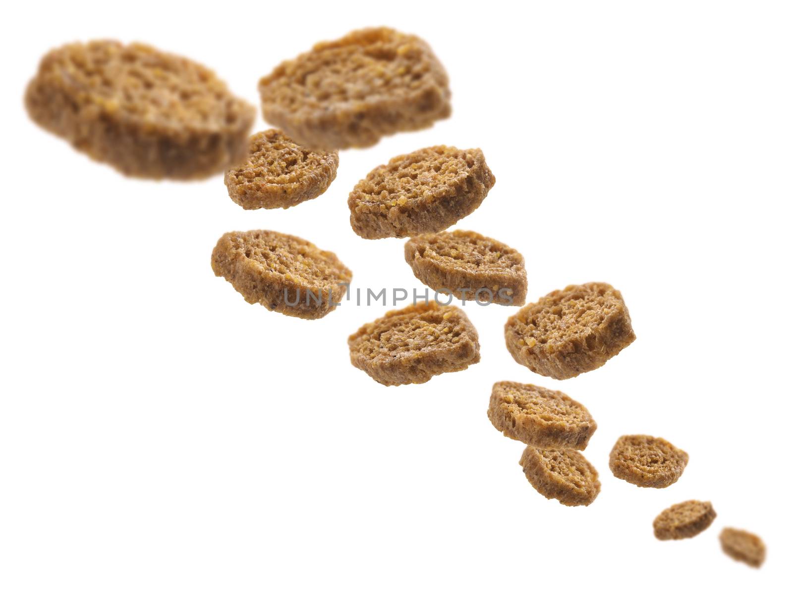 Bread croutons levitate on a white background.