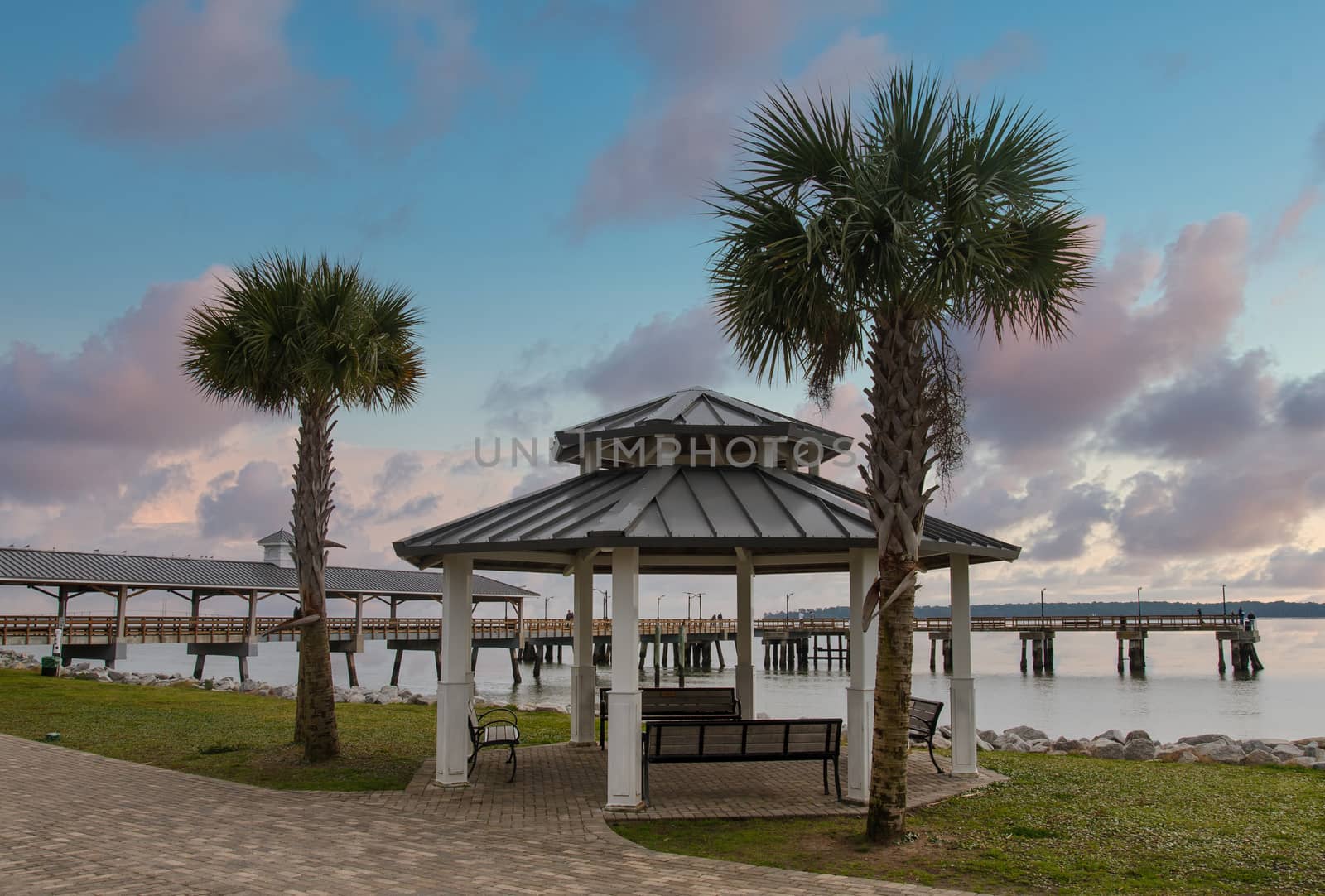 An empty pier in winter under grey, cloudy skies