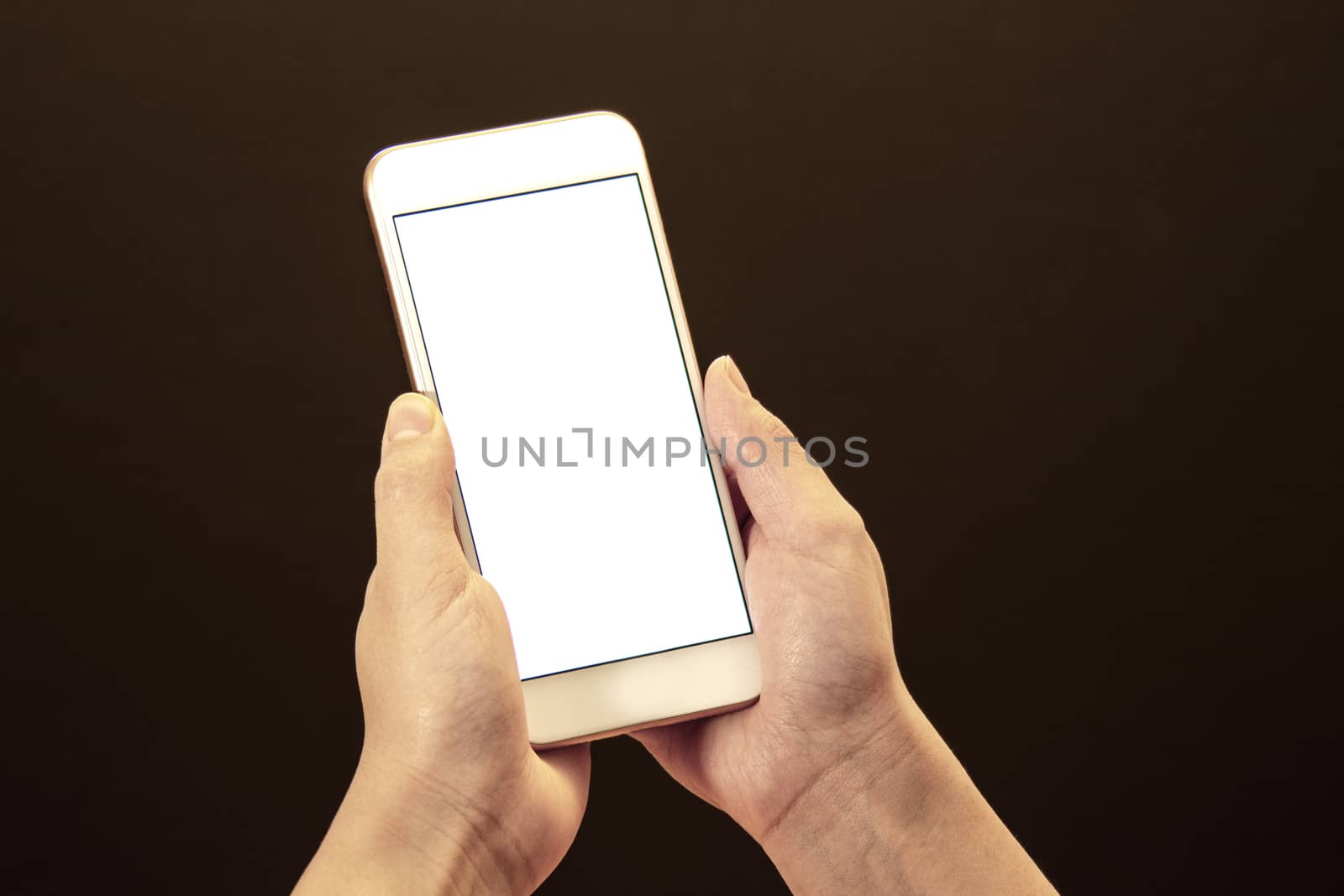 Woman holds a smart phone on her hands on a black background by oasisamuel