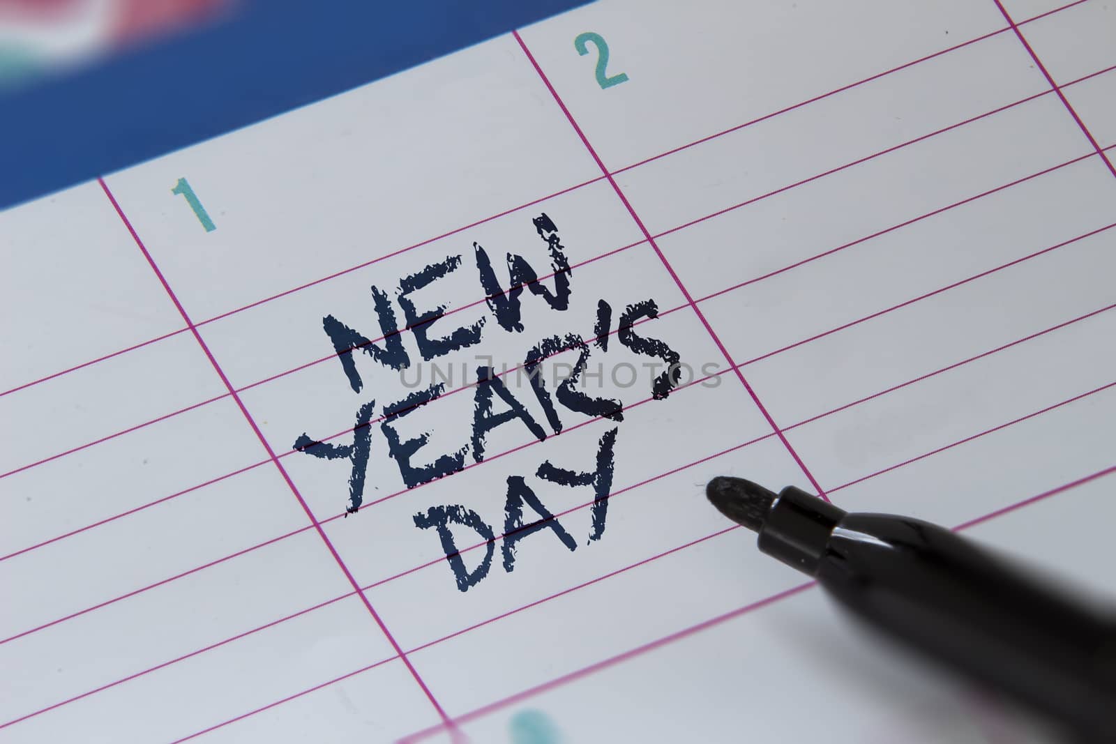 New Year's Day on a calendar with with a highlighter. January 1. by oasisamuel