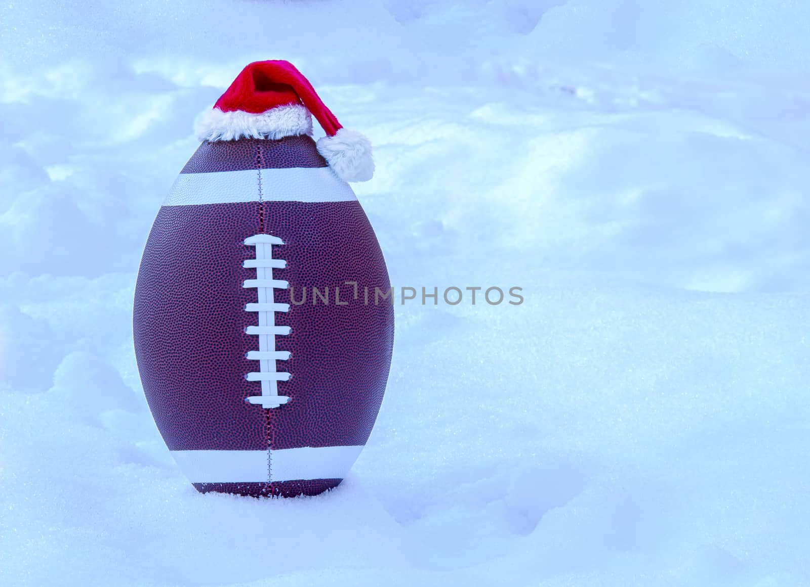 American football wearing a Santa Claus Hat on Snow by oasisamuel