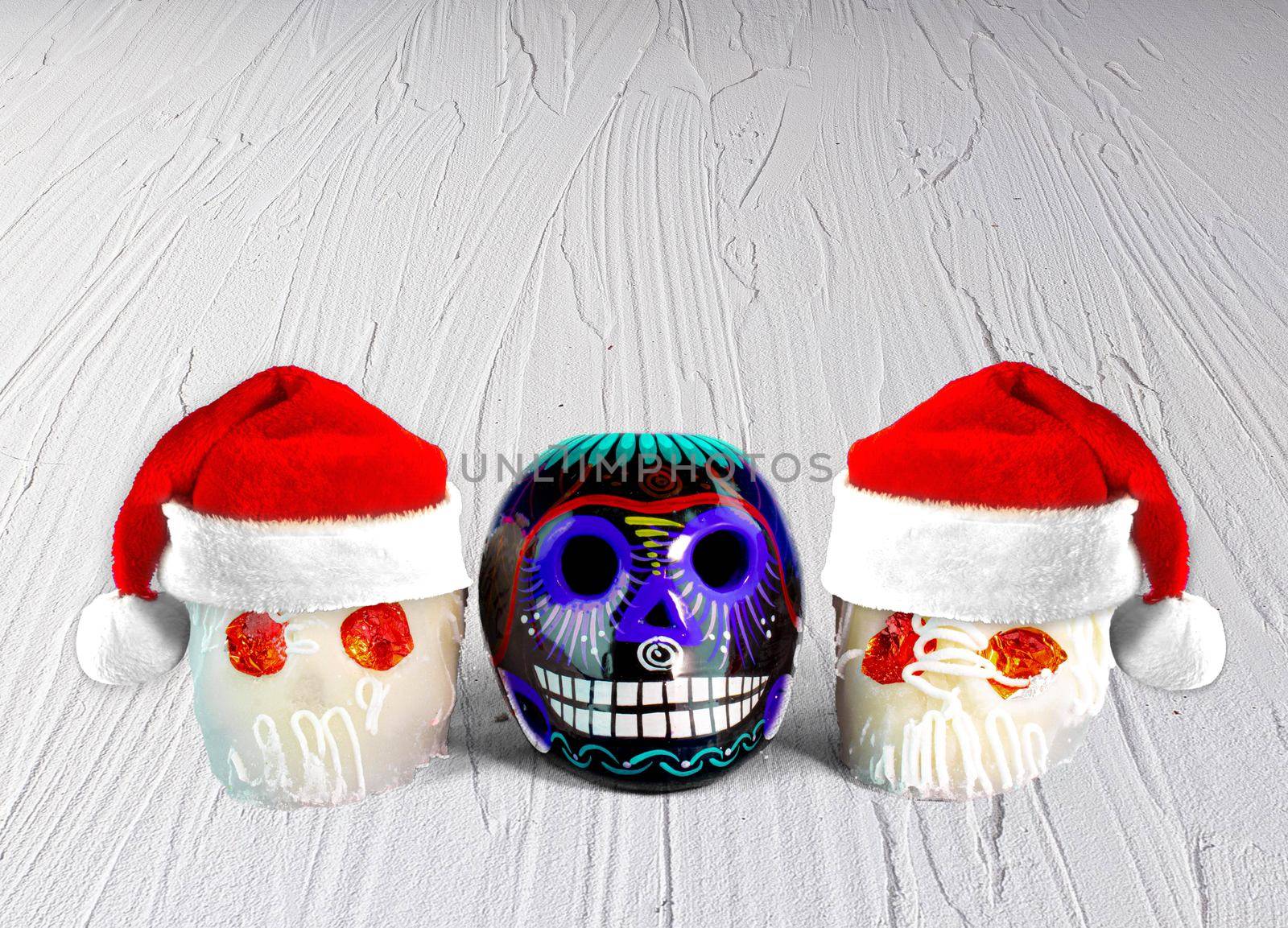 Traditional Mexican sugar skulls with Santa hats. Mexican Christmas.(calaveritas de azucar para navidad en México) mix cultures. by oasisamuel