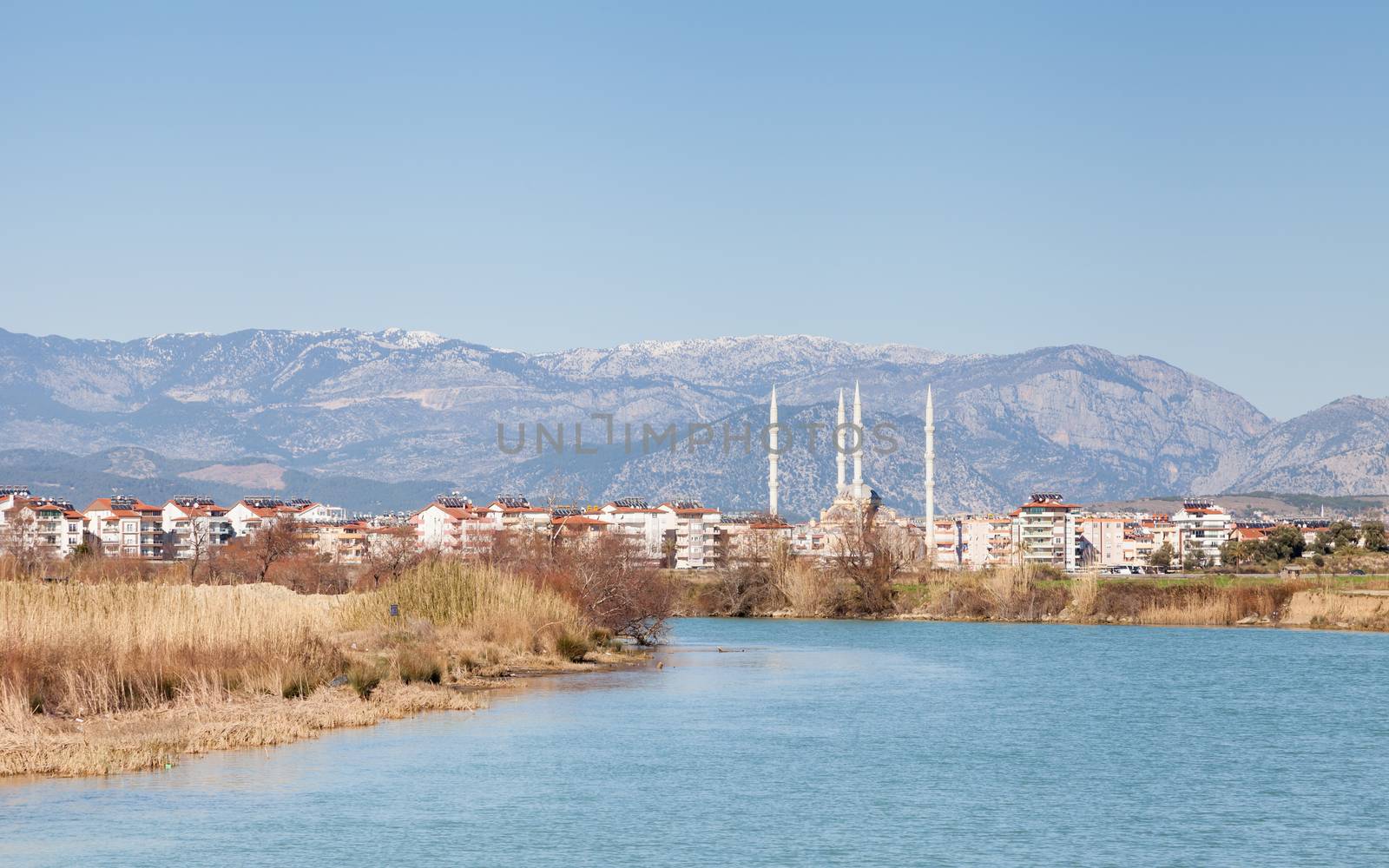 The view looking up Manavgat River towards the town of Manavgat in the province of Antalya, southern Turkey. Kulliye mosque, with its four minarets can be seen dominating the skyline.