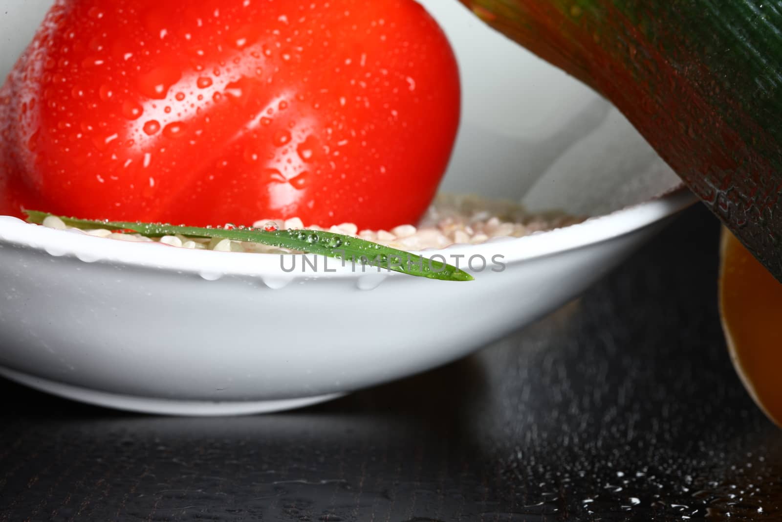 Healthy fresh organic food with water drops with rice and red pepperoni and a green leaf