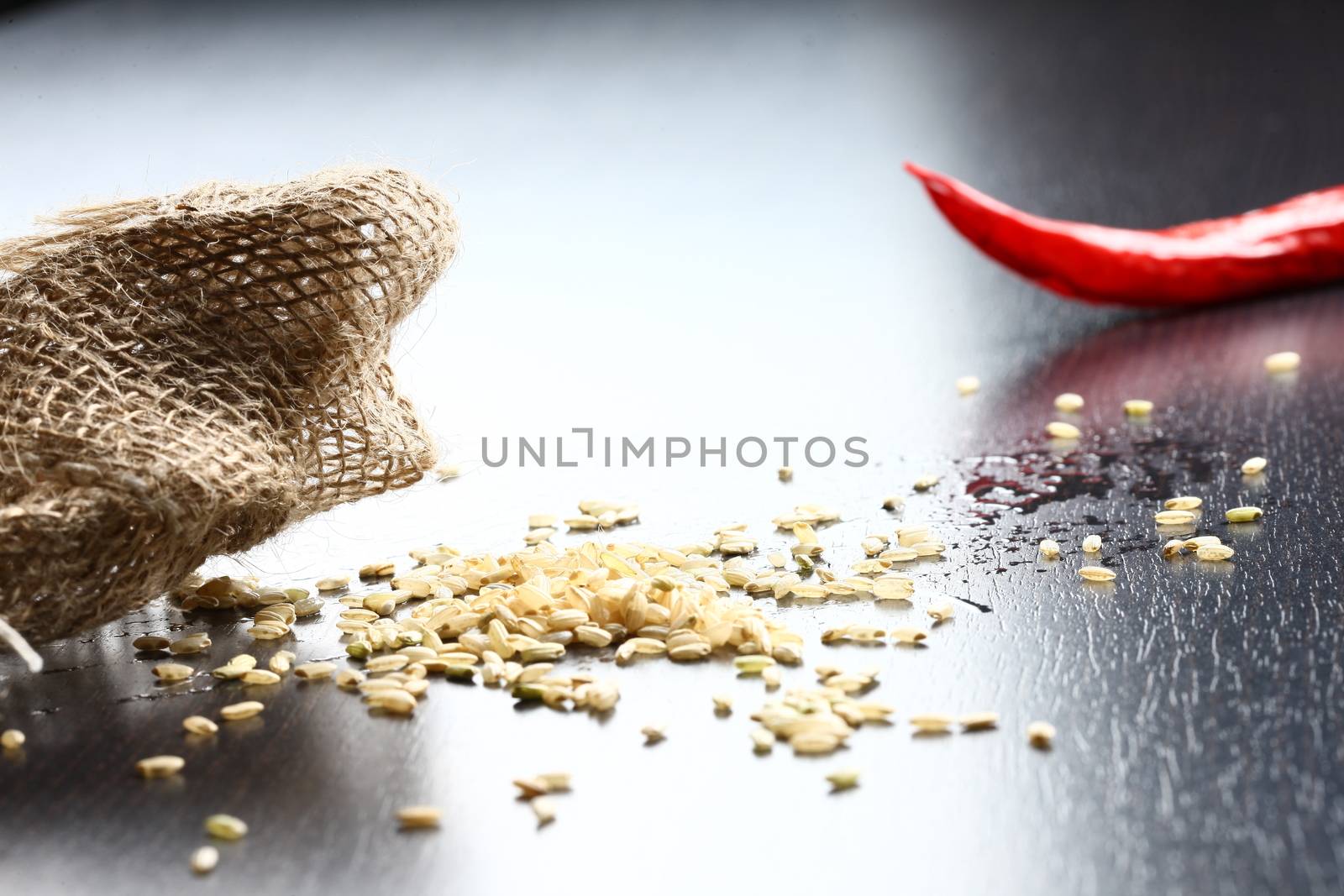 rice corn with on wooden table with cotton bag showing with a red chilli in back