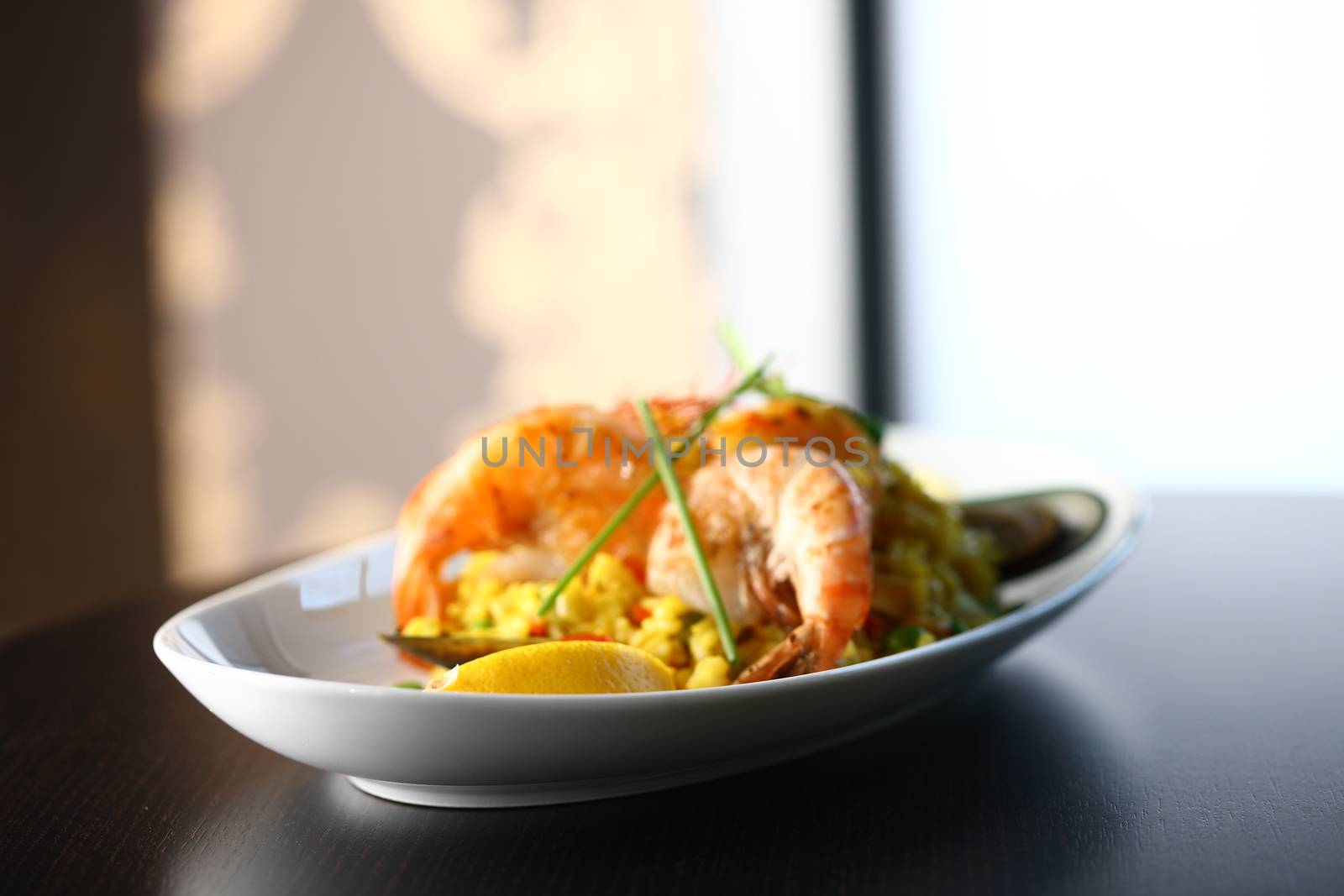 dish with shrimp and vegetable on a table top with light background