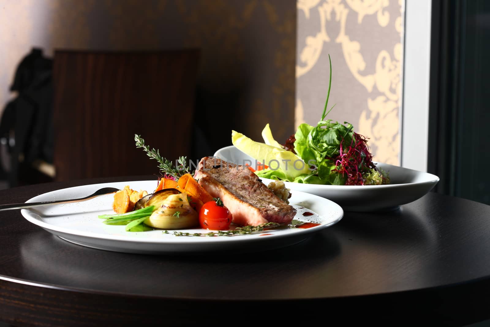 good food - tasty food. a good meal with meat and tomato on a restaurant background