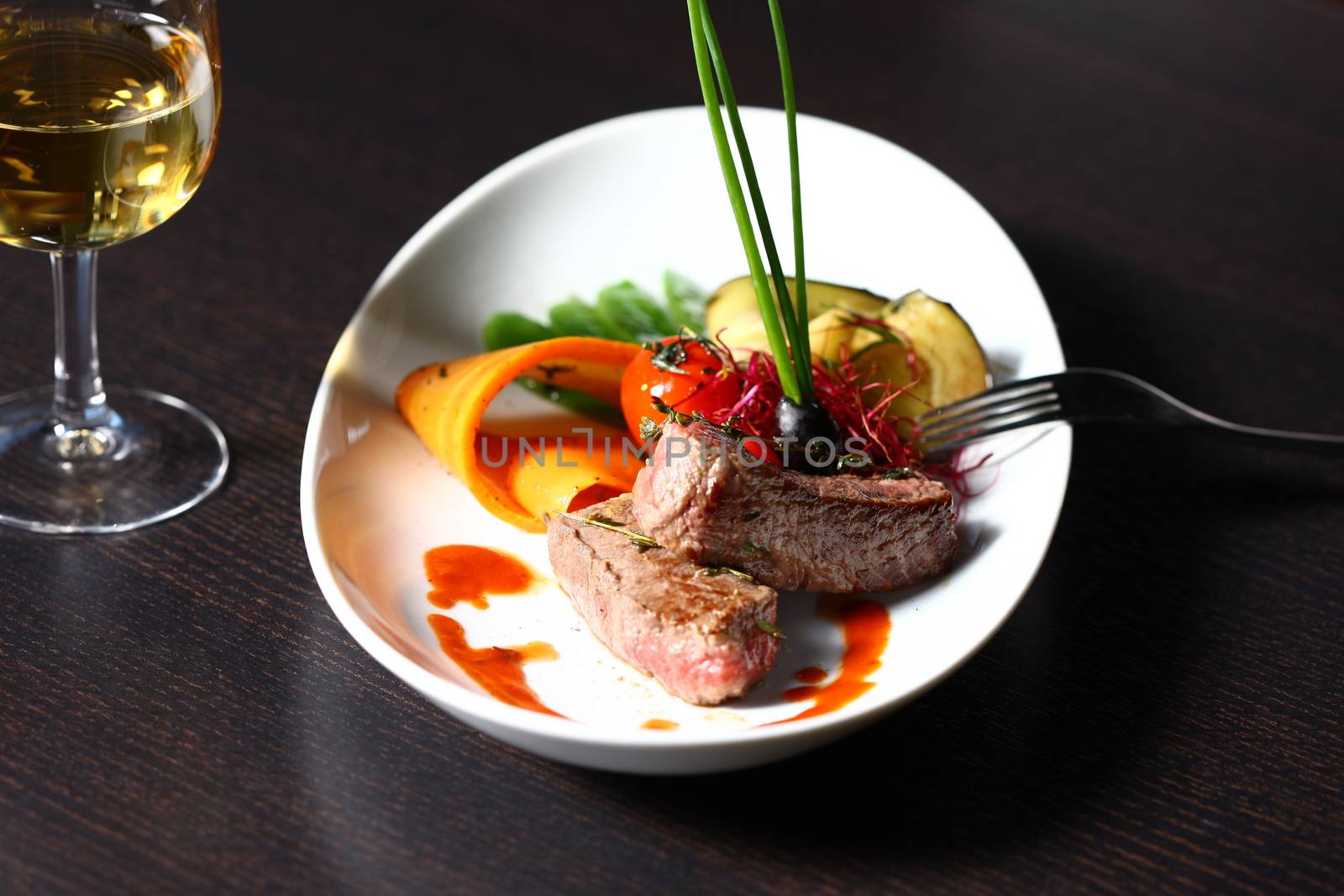 close up of a dish with meal, rice and mushrooms and a glass of wine in background. Shot from above with copy space