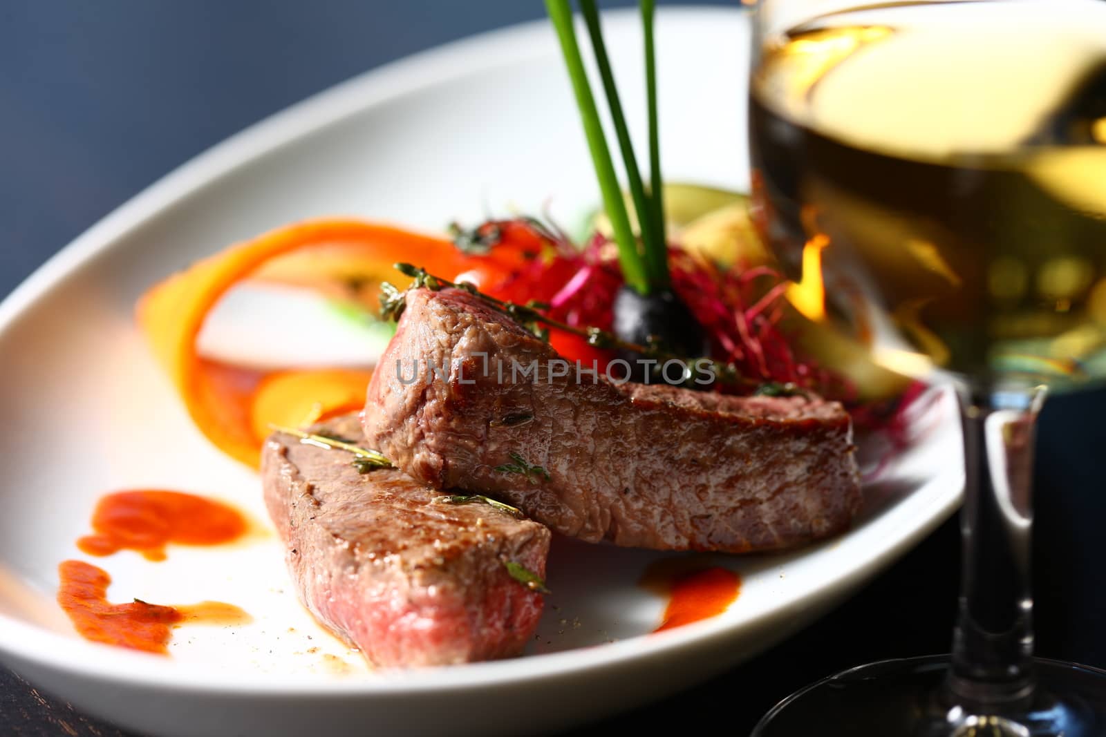 Close up a meat on a dish. A good meal on a white plate with nice decorations