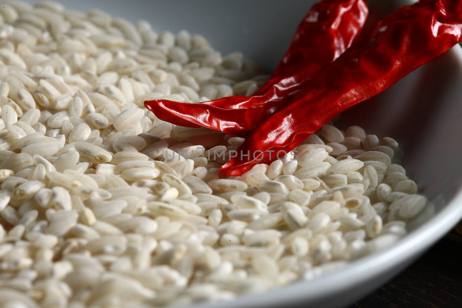 Extreme close up of hot chilli and rice corns in a white bowl