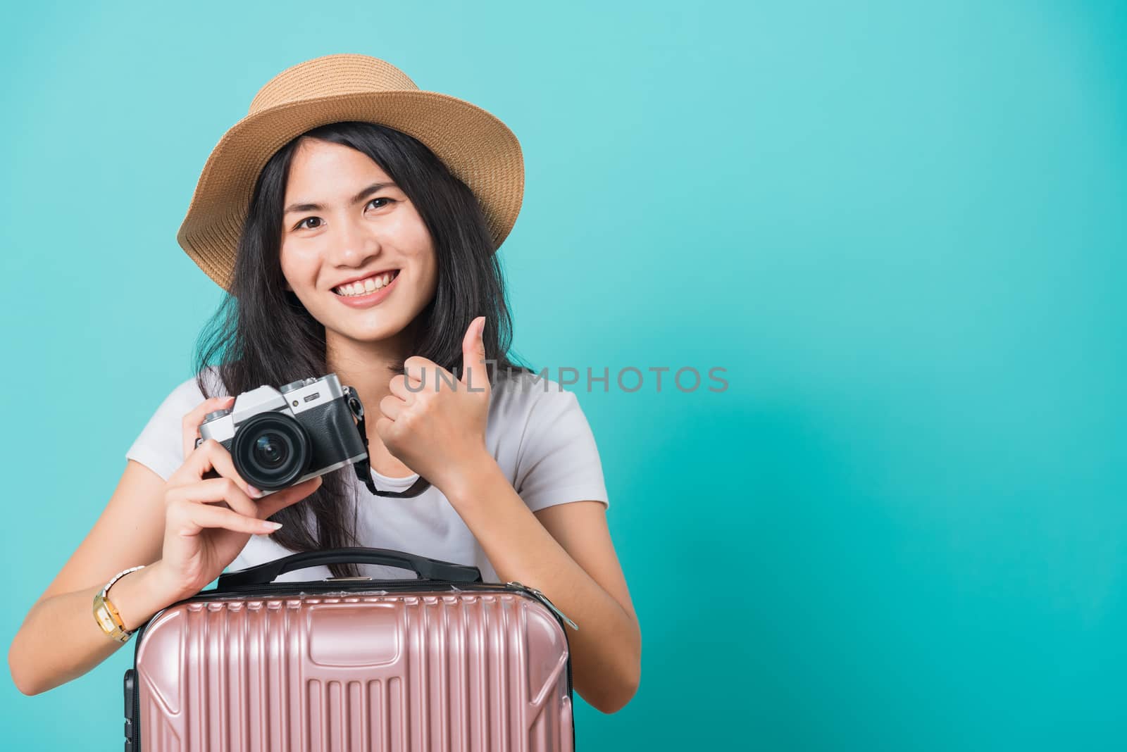 woman wear white t-shirt her holding suitcase bag and photo mirr by Sorapop