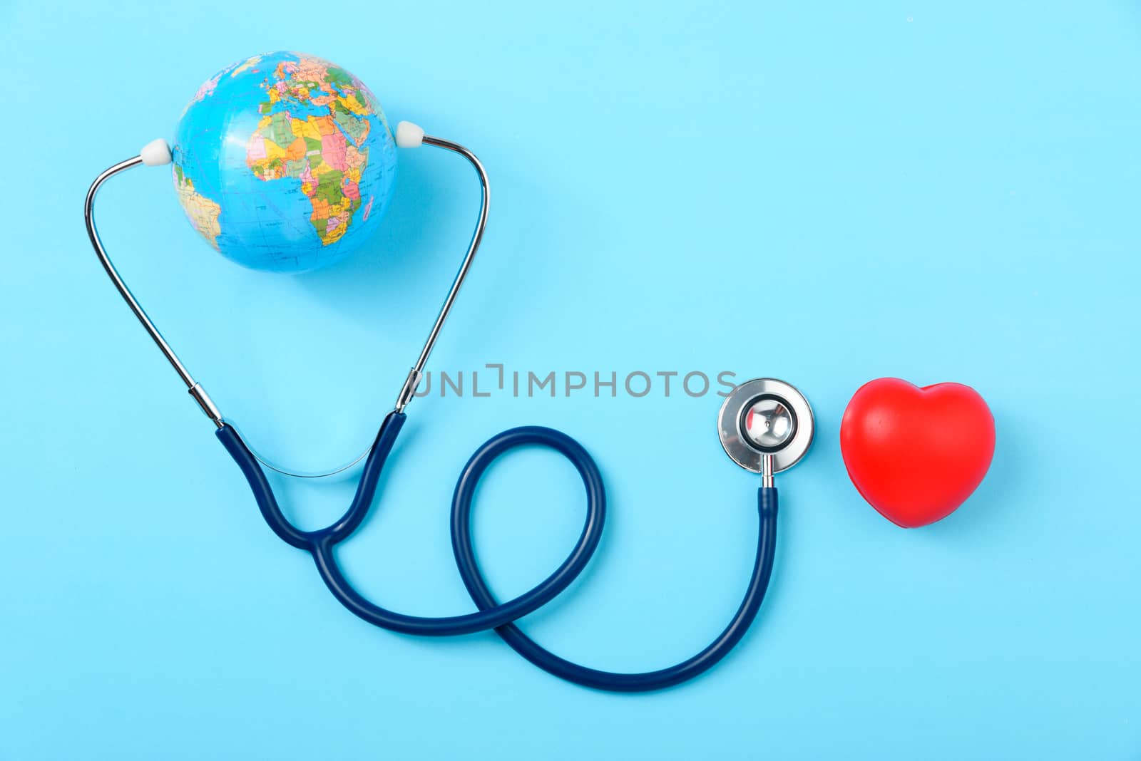 World health day concept, Stethoscope, globe and red heart on blue background with copy space. Global health care