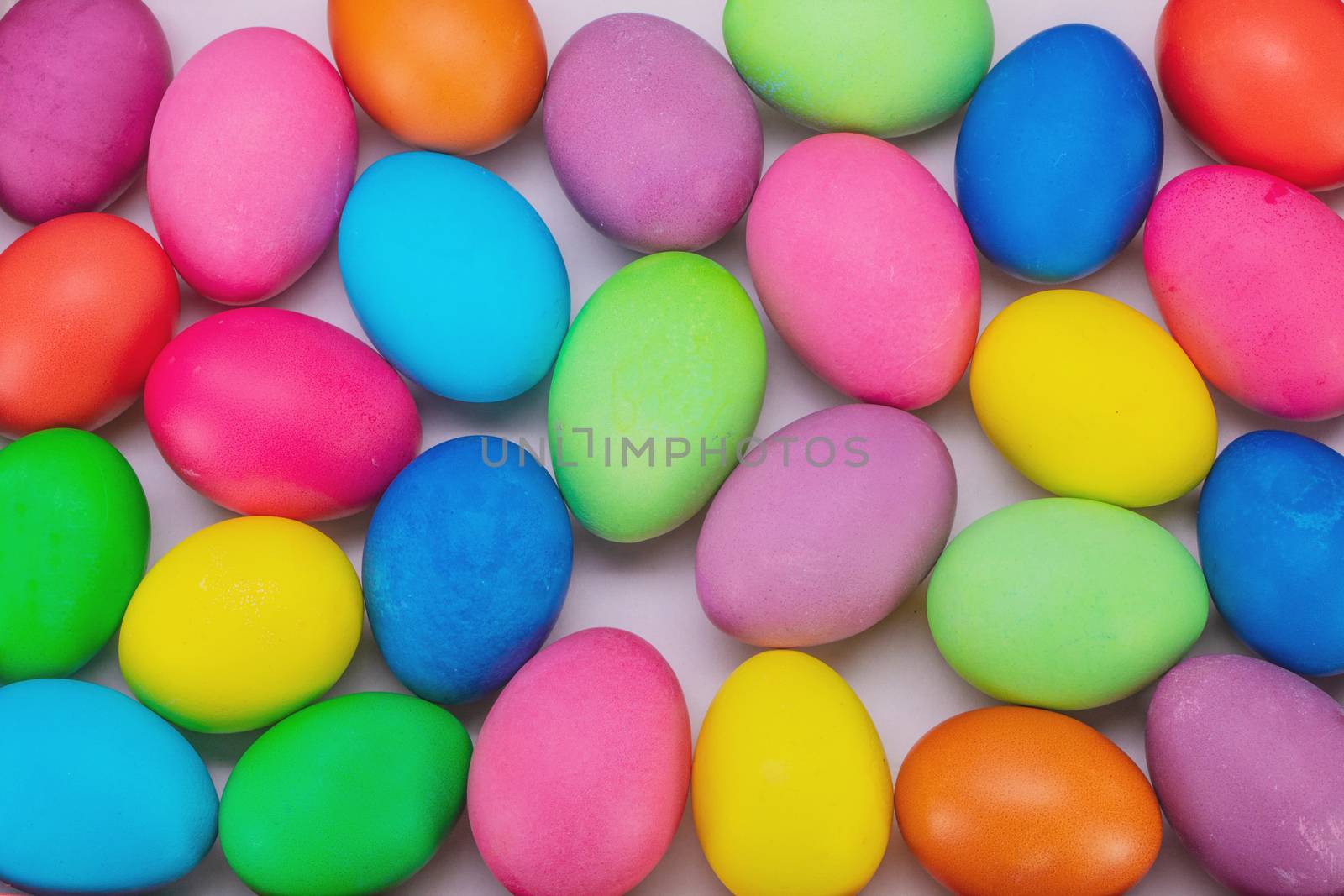 Many colorful easter eggs multicolored close up background top view