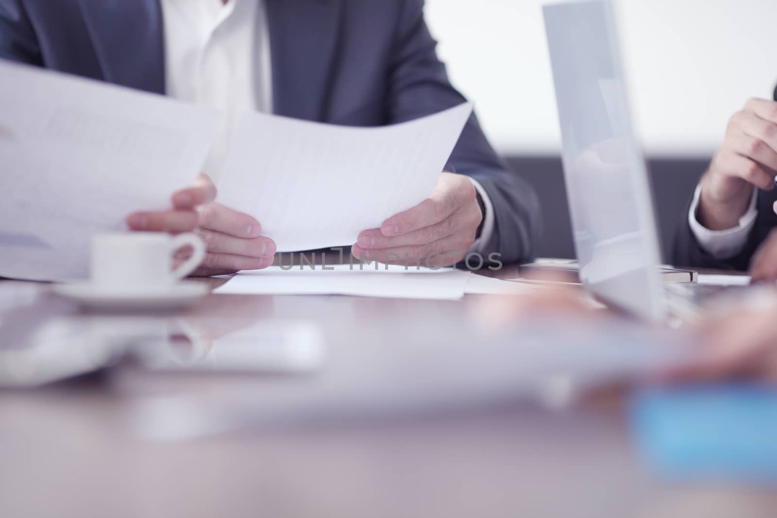 Close-up of business partners hands holding document papers , business meeting negotiation concept