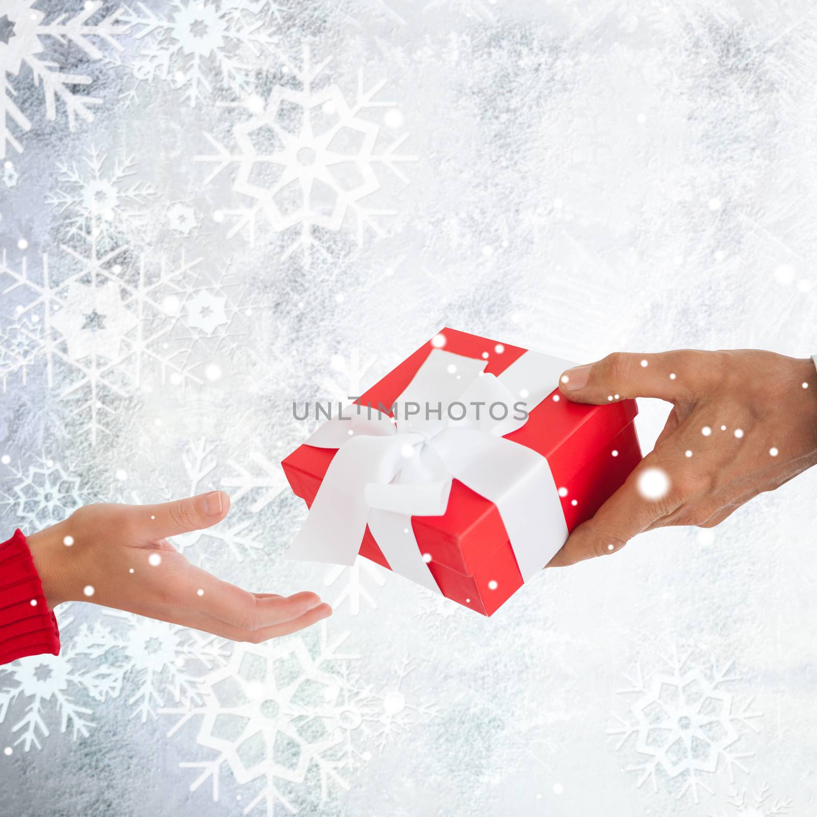 Couple holding gift against silver snow flake pattern design