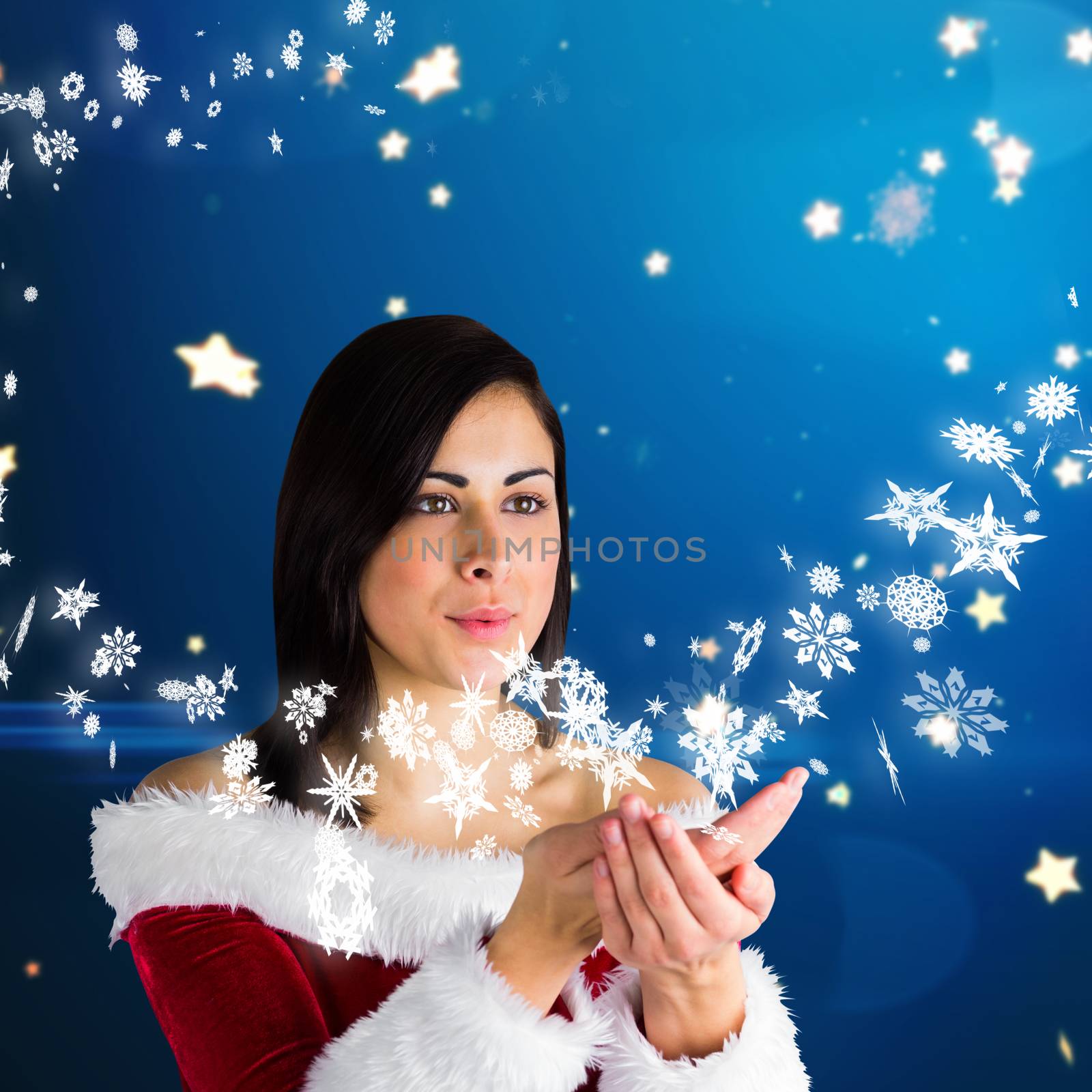 Pretty girl in santa outfit blowing against bright star pattern on blue