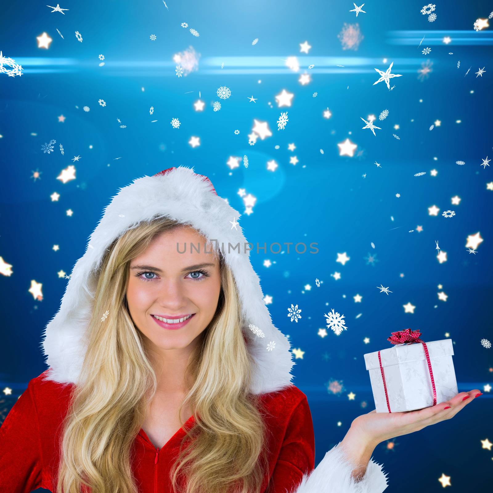 Pretty girl in santa outfit holding gift against bright star pattern on blue