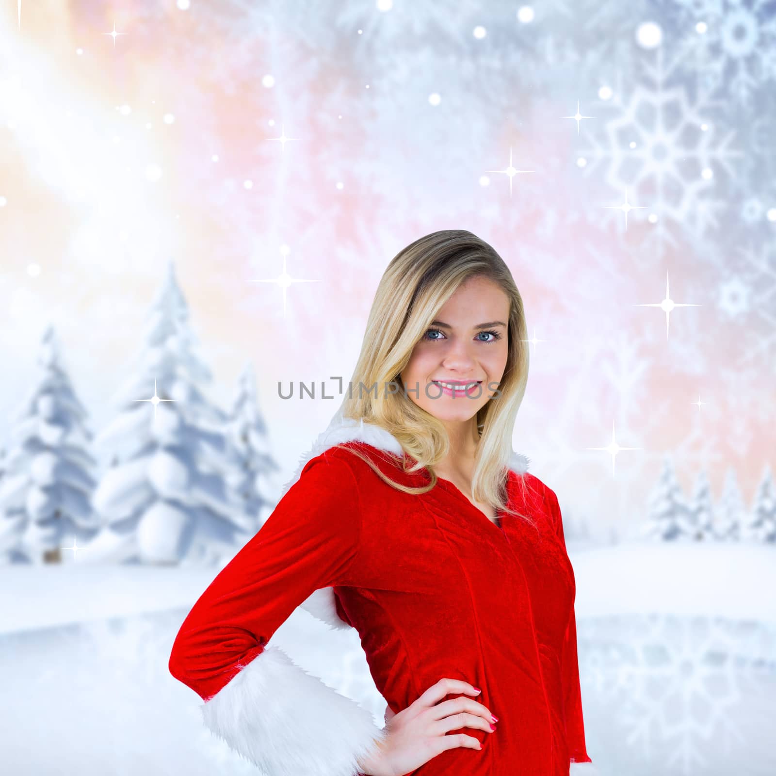 Pretty girl smiling in santa outfit against snowy landscape with fir trees