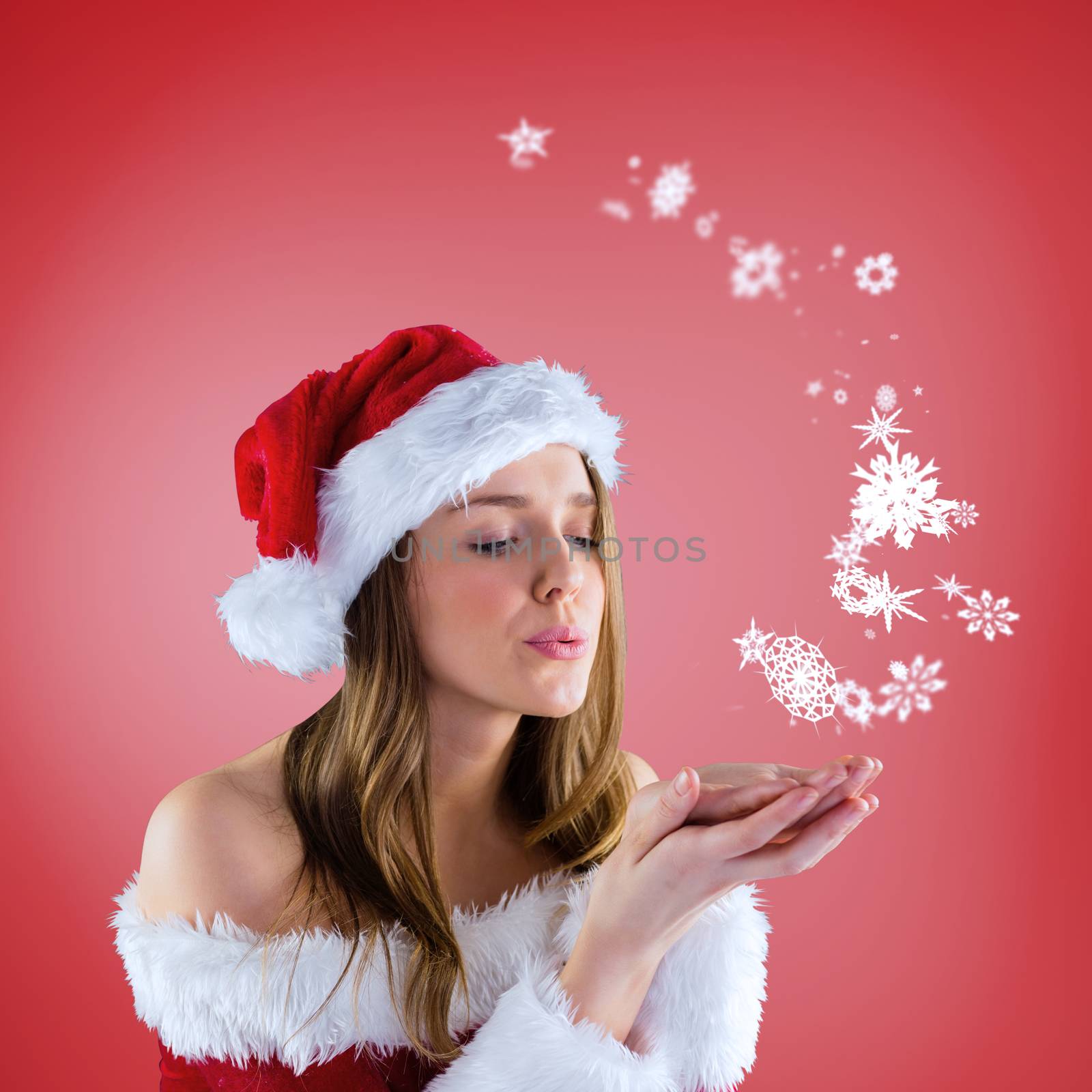 Composite image of sexy santa girl blowing over hands against red vignette