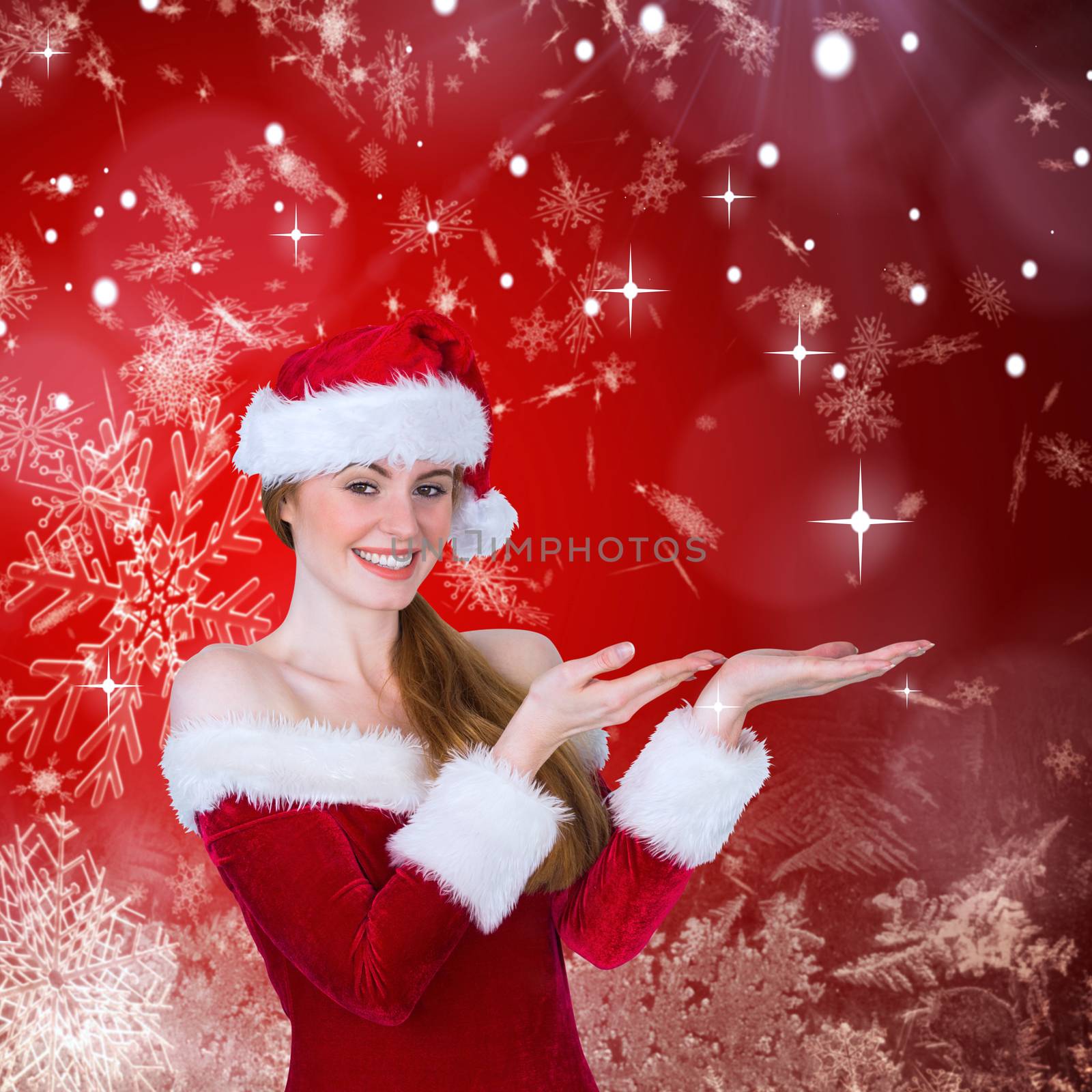 Pretty girl in santa costume holding hand out against red snow flake pattern design