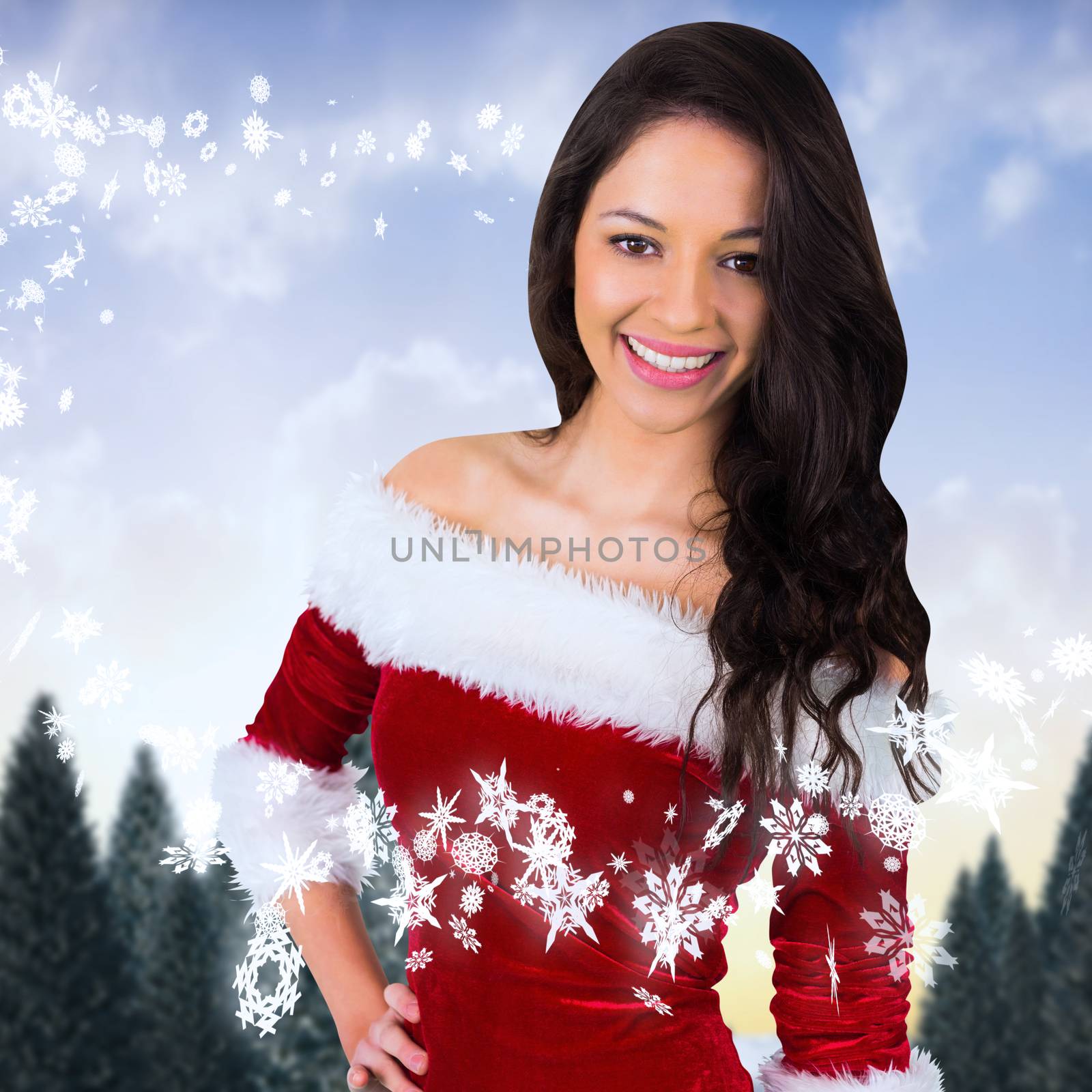 Pretty girl smiling in santa outfit against snowy landscape with fir trees