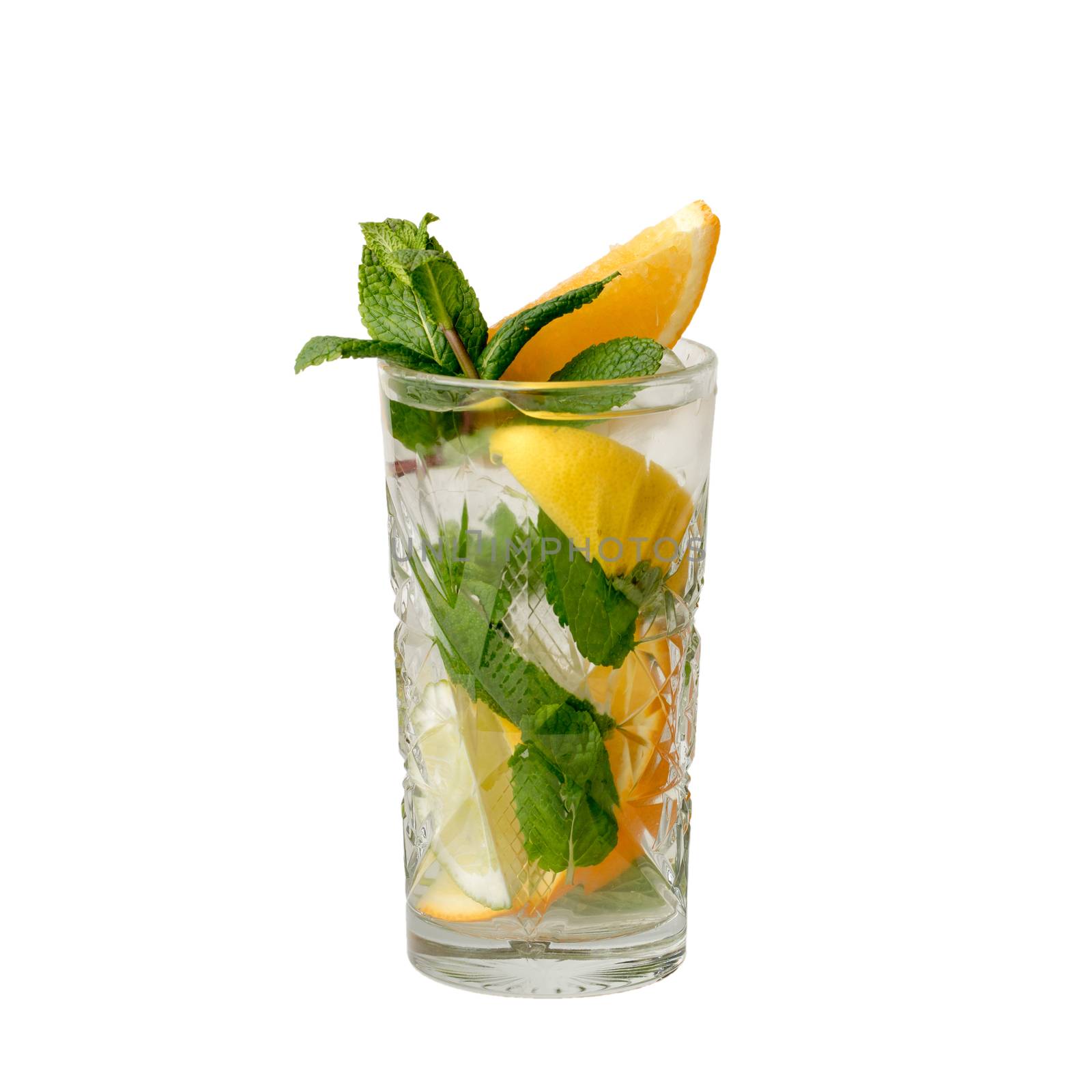 Cold alcohol cocktail drink with slices of lemon and lime, mint leaf isolation on a white