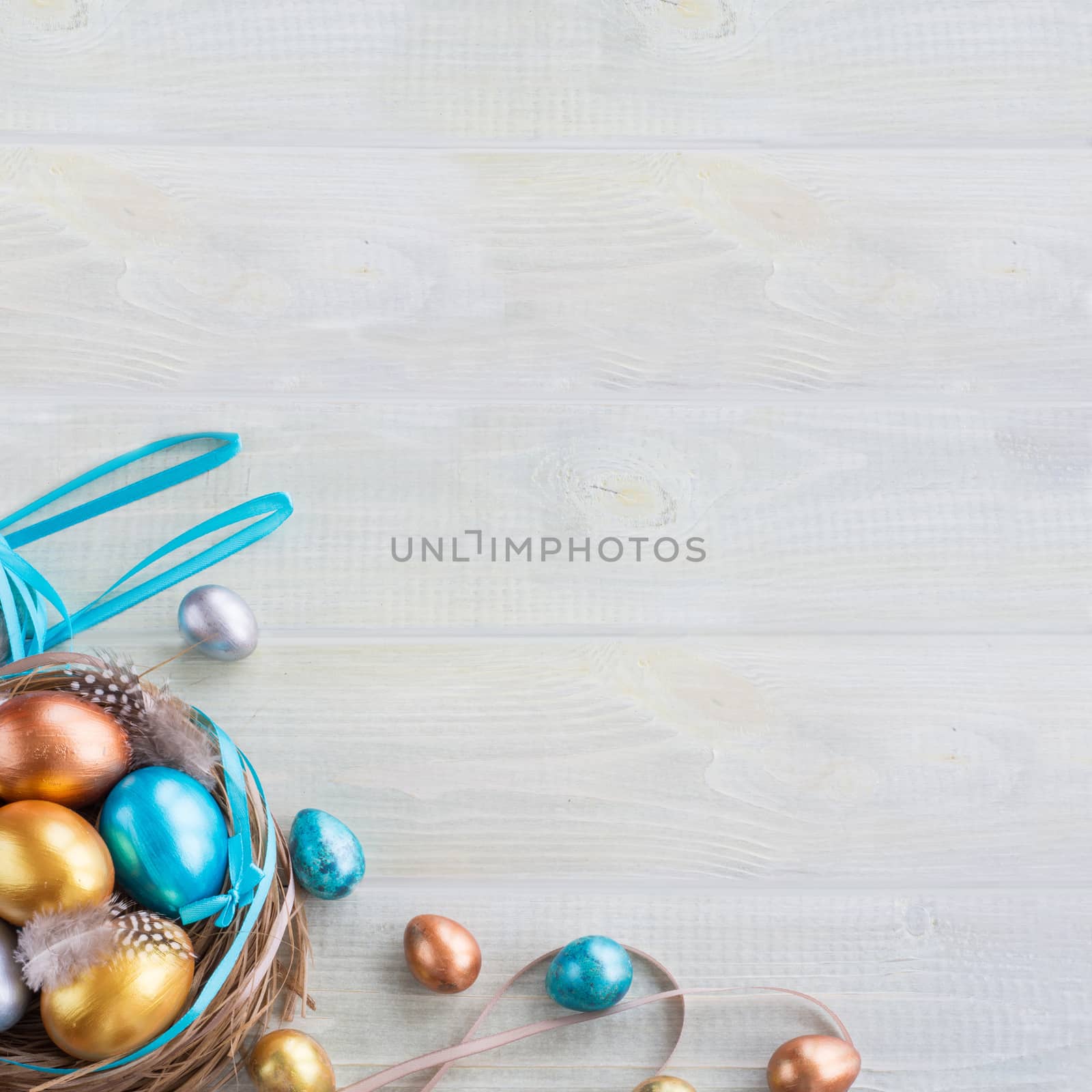 Beautiful Happy Easter holiday greeting banner with easter nest with colored eggs and decorated with ribbons over light wooden background with copy space for text