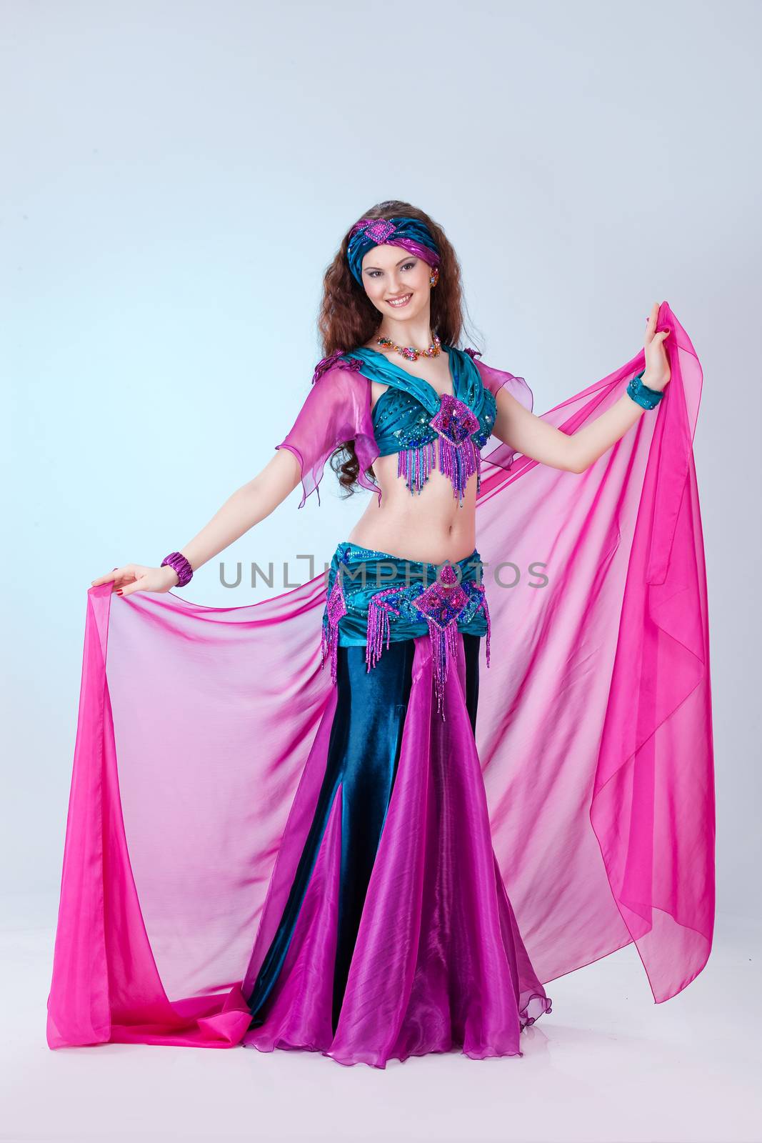 Young beautiful woman dressed in eastern style on isolated background