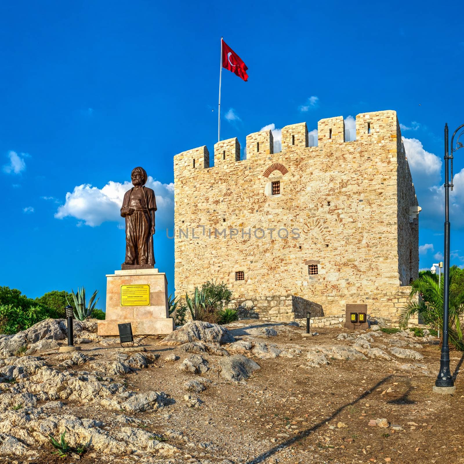 Kusadasi, Turkey – 07.18.2019.  Kusadasi castle in Turkey and pleasure boat parking on a summer evening