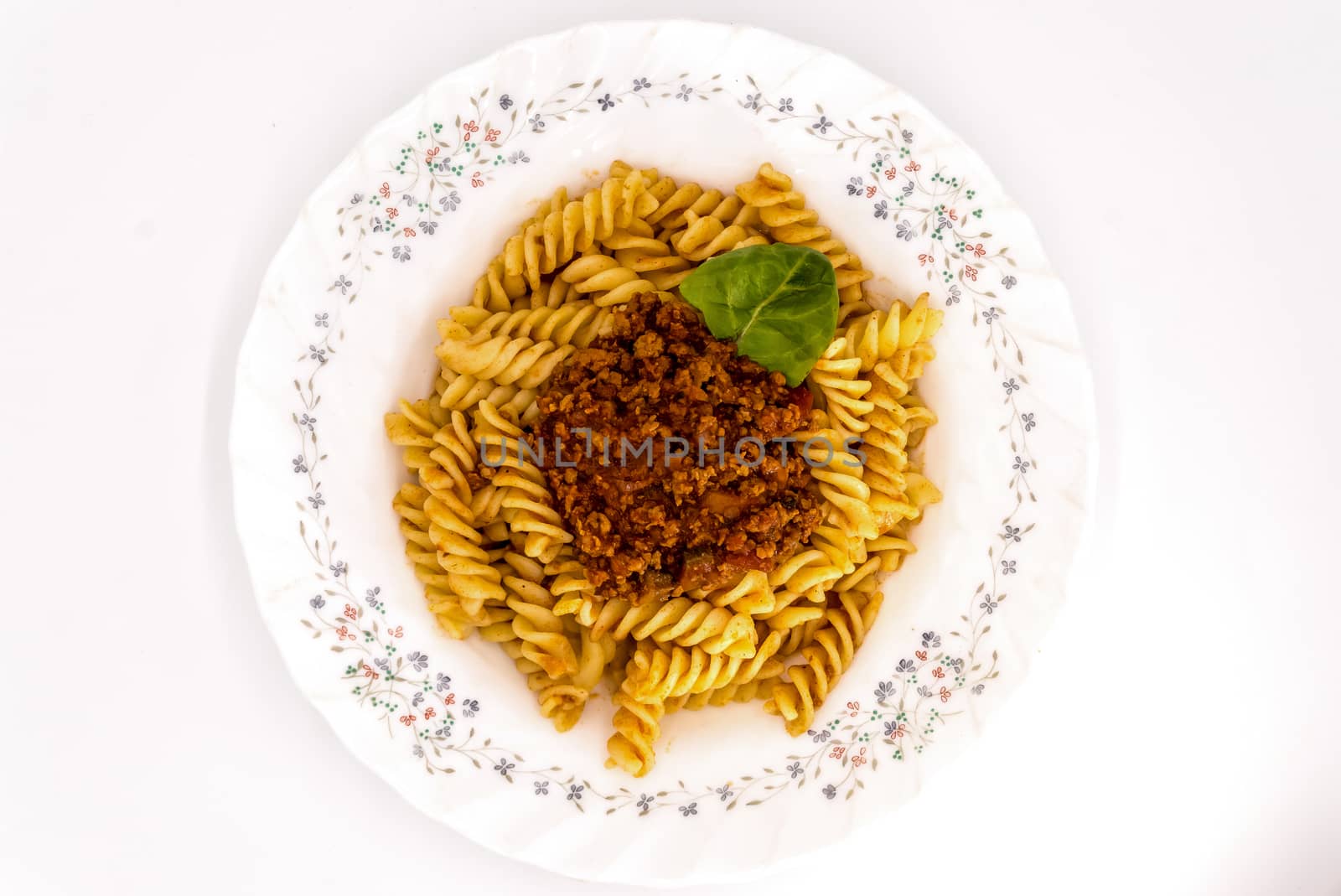 Spirelli with Bolognese Sauce on a white background