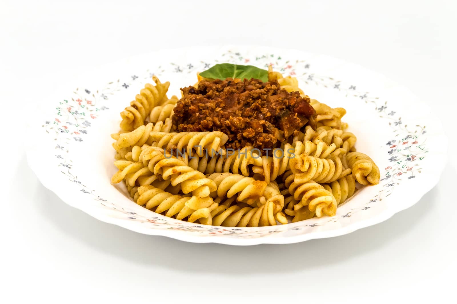 Spirelli with Bolognese Sauce on a white background