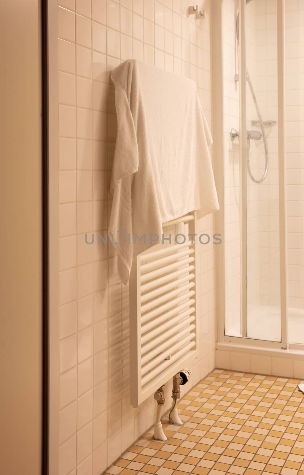 Heated towel rack in an old bathroom by michaklootwijk