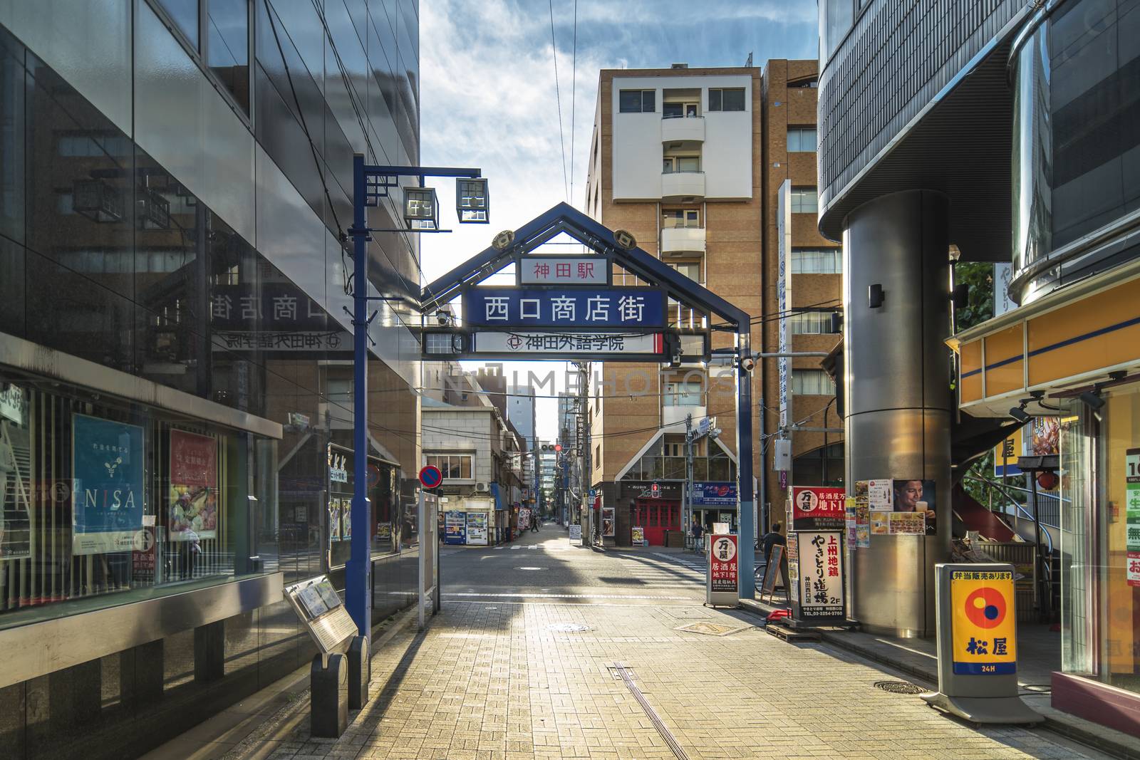 Blue metal entrance gate of the shopping street from the west exit of Kanda Station on the Yamanote Line. The street extends over 300 meters and has no less than 100 shops.