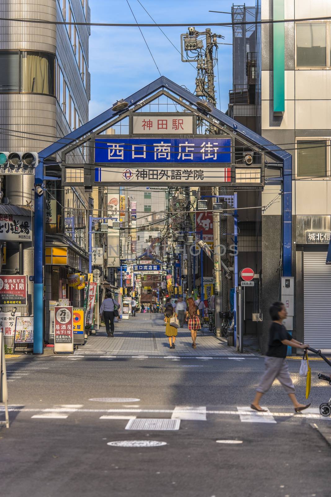 Blue metal entrance gate of the shopping street from the west exit of Kanda Station on the Yamanote Line. The street extends over 300 meters and has no less than 100 shops.