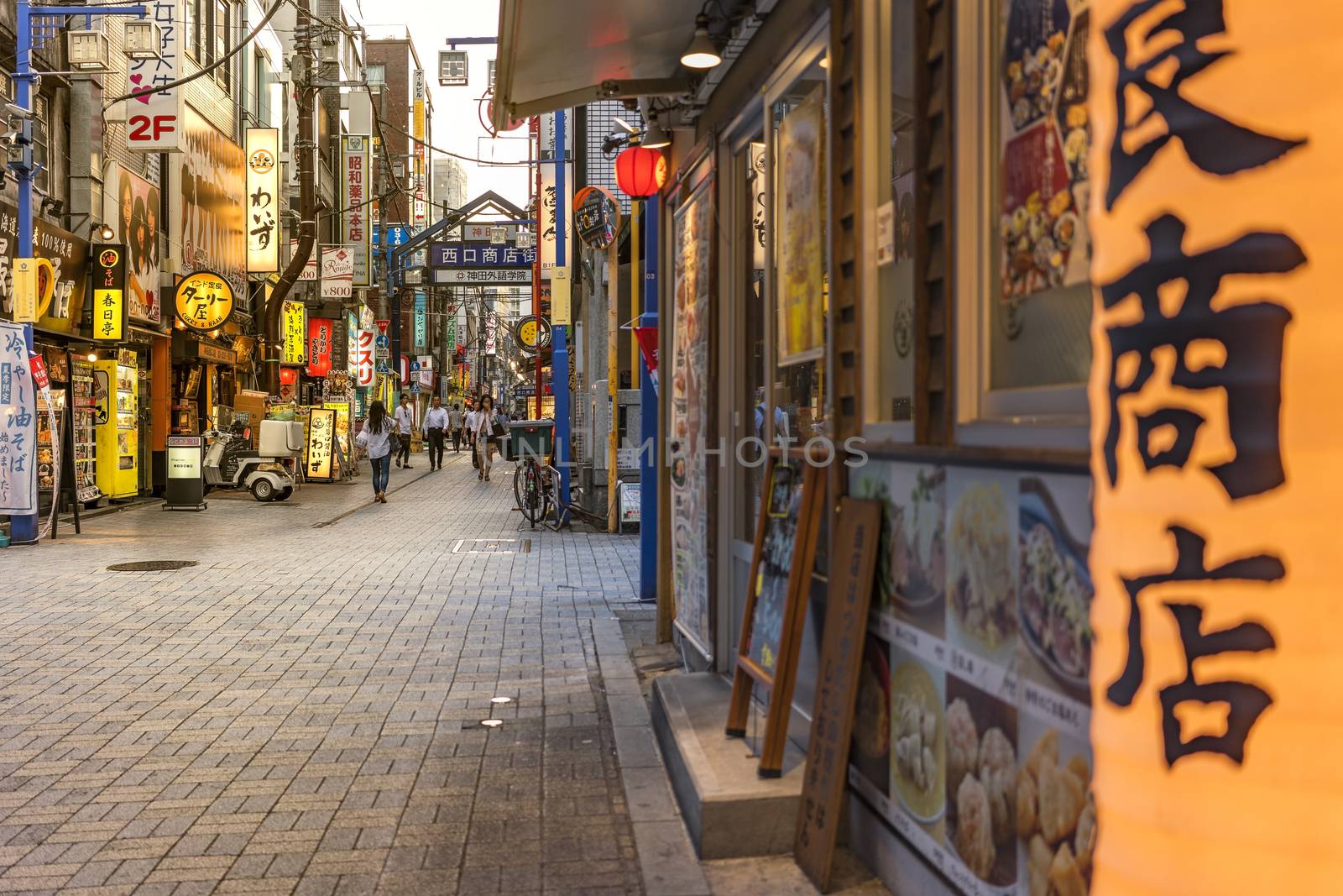 Traditional wooden lantern and blue metal entrance gate of the shopping street from the west exit of Kanda Station on the Yamanote Line. The street extends over 300 meters and has no less than 100 shops, restaurants or pachinko.