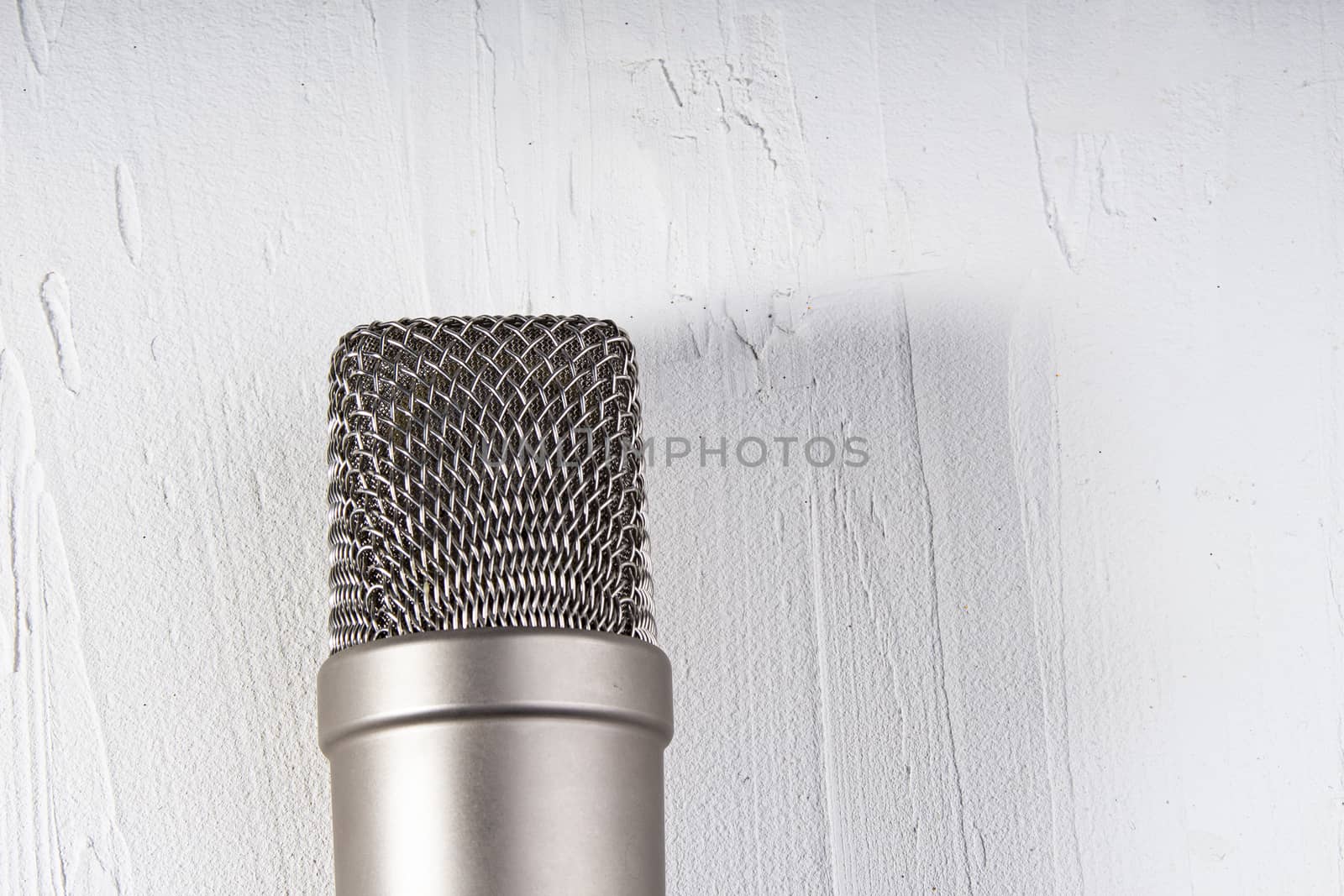 Microphone on lay on a texture background with a light