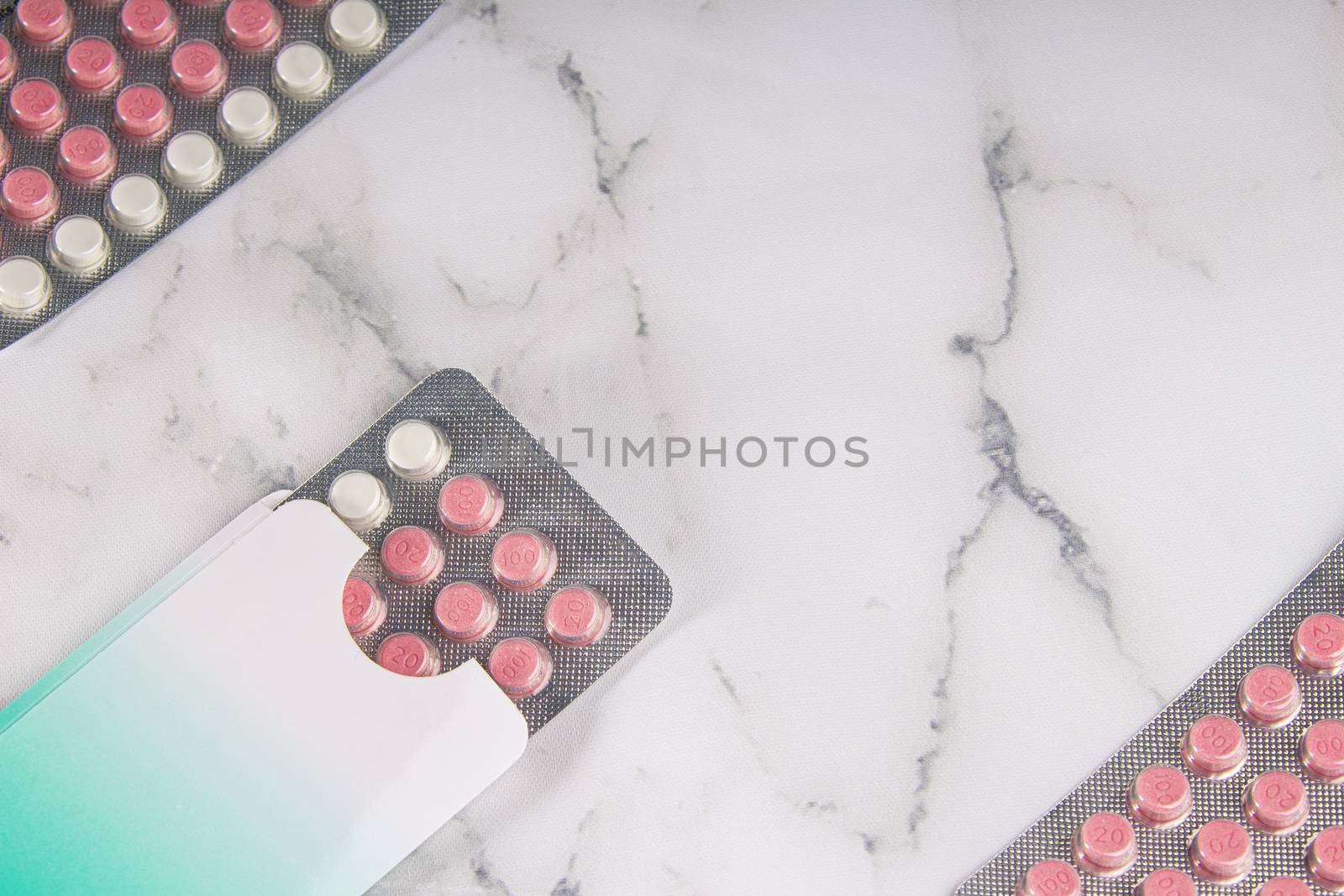 Birth control pills on a marble background by oasisamuel