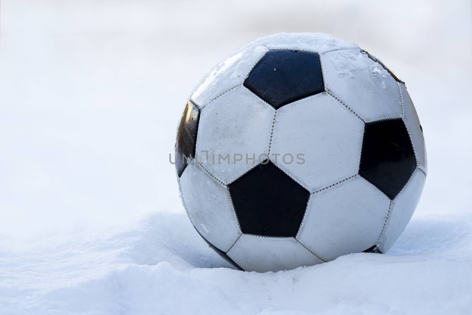 Football, soccer ball on snow by oasisamuel
