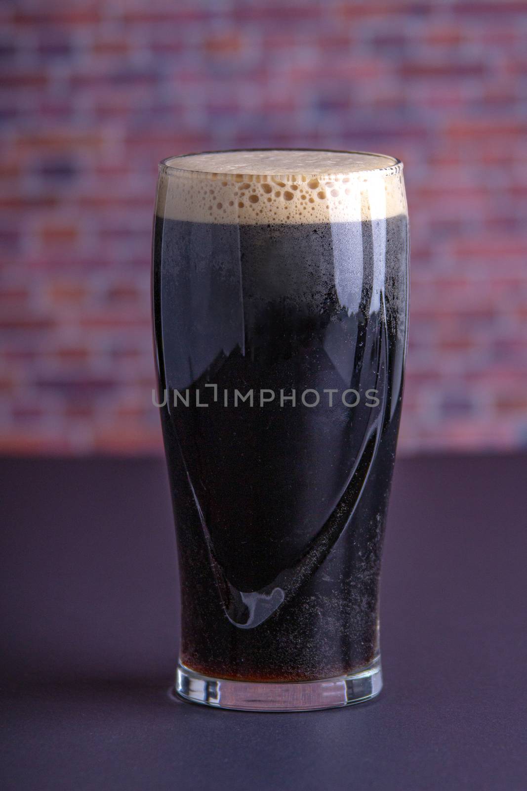 A Guinness dark Irish dry stout beer glass that originated in th by oasisamuel