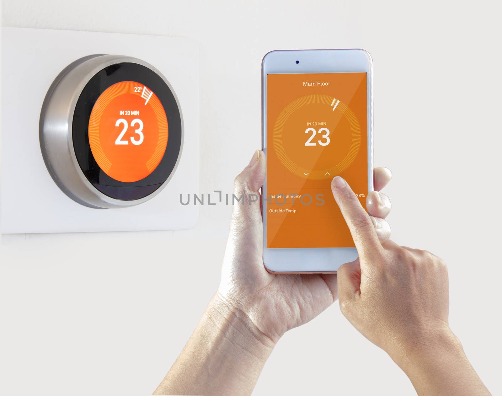 Smart Thermostat and a person setting up the temperature smart device hand hold on a white background by oasisamuel