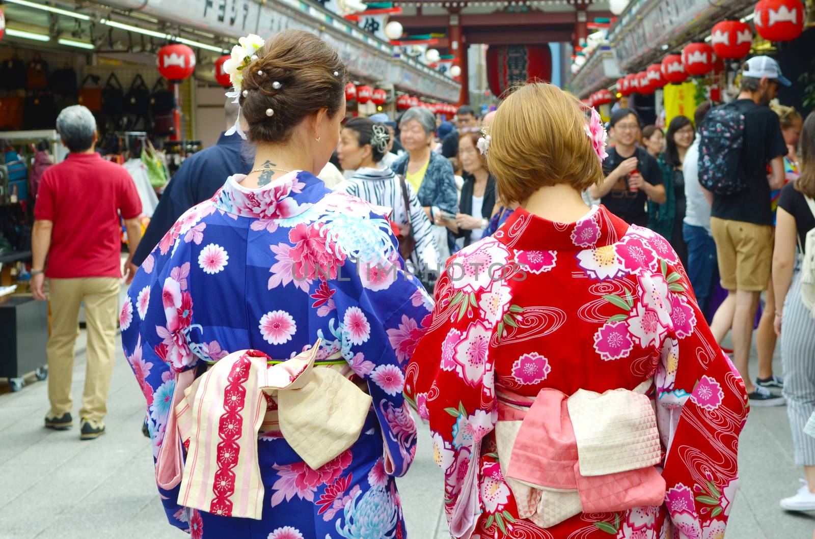 Young girl wearing Japanese kimono standing in front of Sensoji Temple in Tokyo, Japan. Kimono is a Japanese traditional garment. 