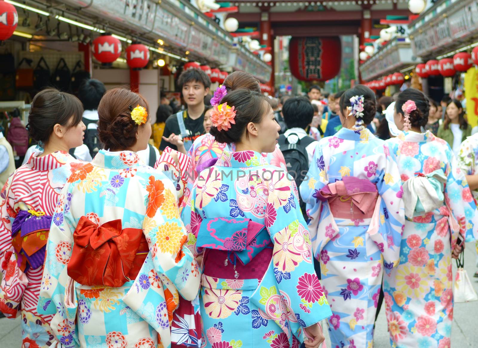 TOKYO JAPAN , MAY 28 2018.Young girl wearing Japanese kimono walking at street in front of  Sensoji Temple in Tokyo, Japan. Kimono is a Japanese traditional garment. 