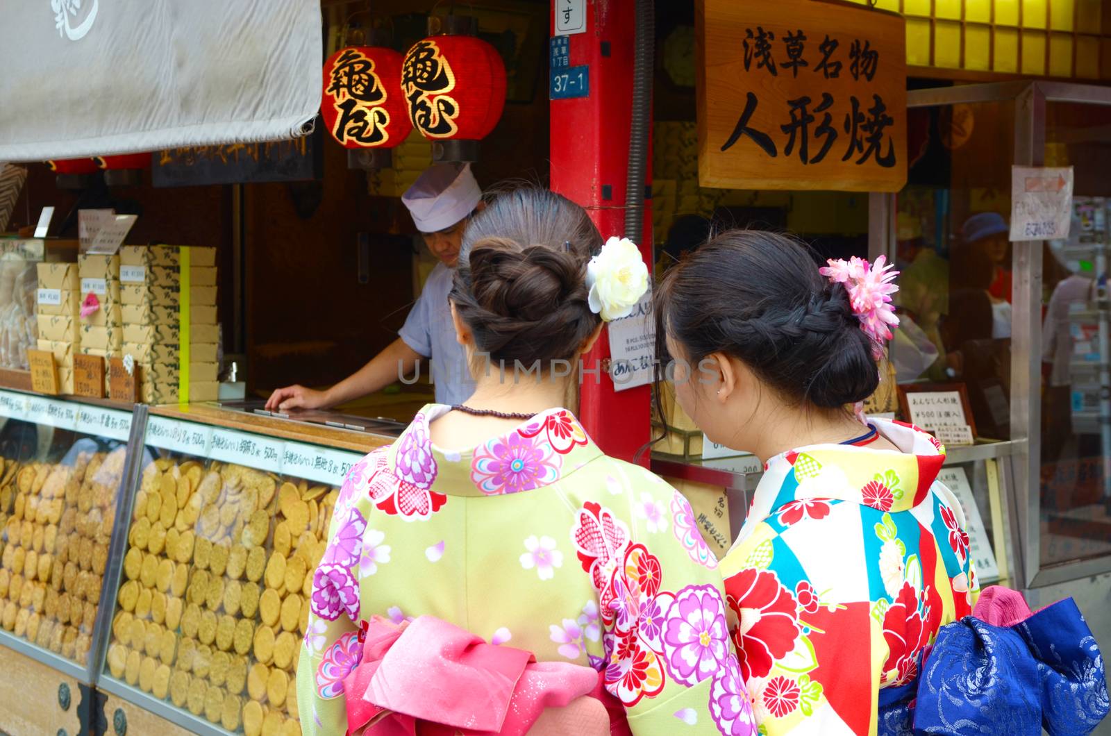 JAPAN, TOKYO, NOV 18 2016. People buy Japanese famous dessert from a food stall at Nakamise Dori shopping street way to Asakusa Sensoji-ji Temple, Tokyo, Japan. 