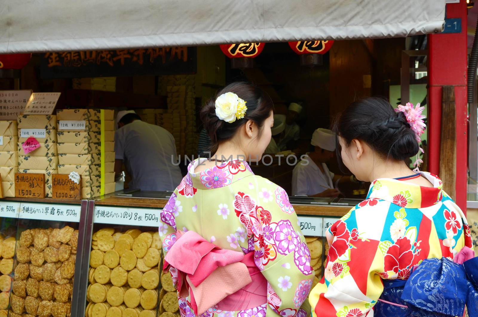 JAPAN, TOKYO, NOV 18 2016. People buy Japanese famous dessert from a food stall at Nakamise Dori shopping street way to Asakusa Sensoji-ji Temple, Tokyo, Japan. 