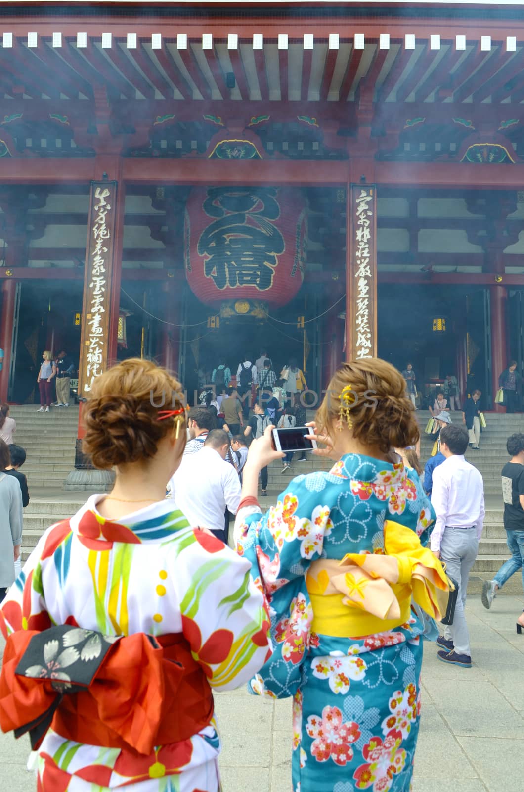Young girls wearing Japanese kimono standing in front of Sensoji Temple in Tokyo, Japan. Kimono is a Japanese traditional garment. 