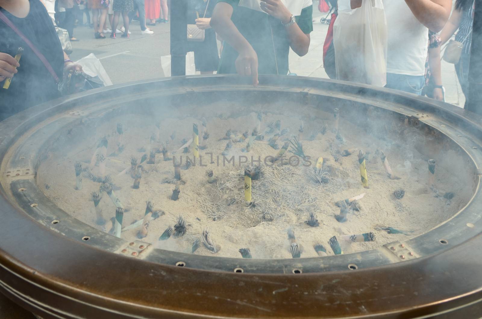 Incense sticks and ash bowl in the Senso-ji temple of the Asakusa district of Tokyo, Japan