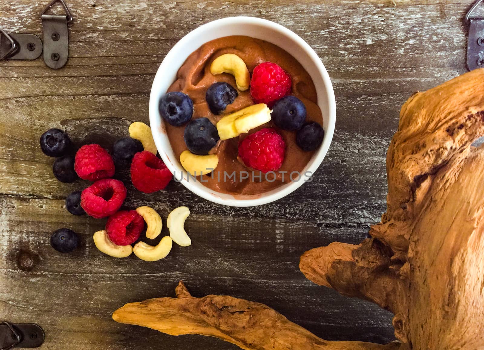 Fruit and mousse on flat wood and white background. A breakfast ready to be served, Raw and organic food on wood with wood decoration.