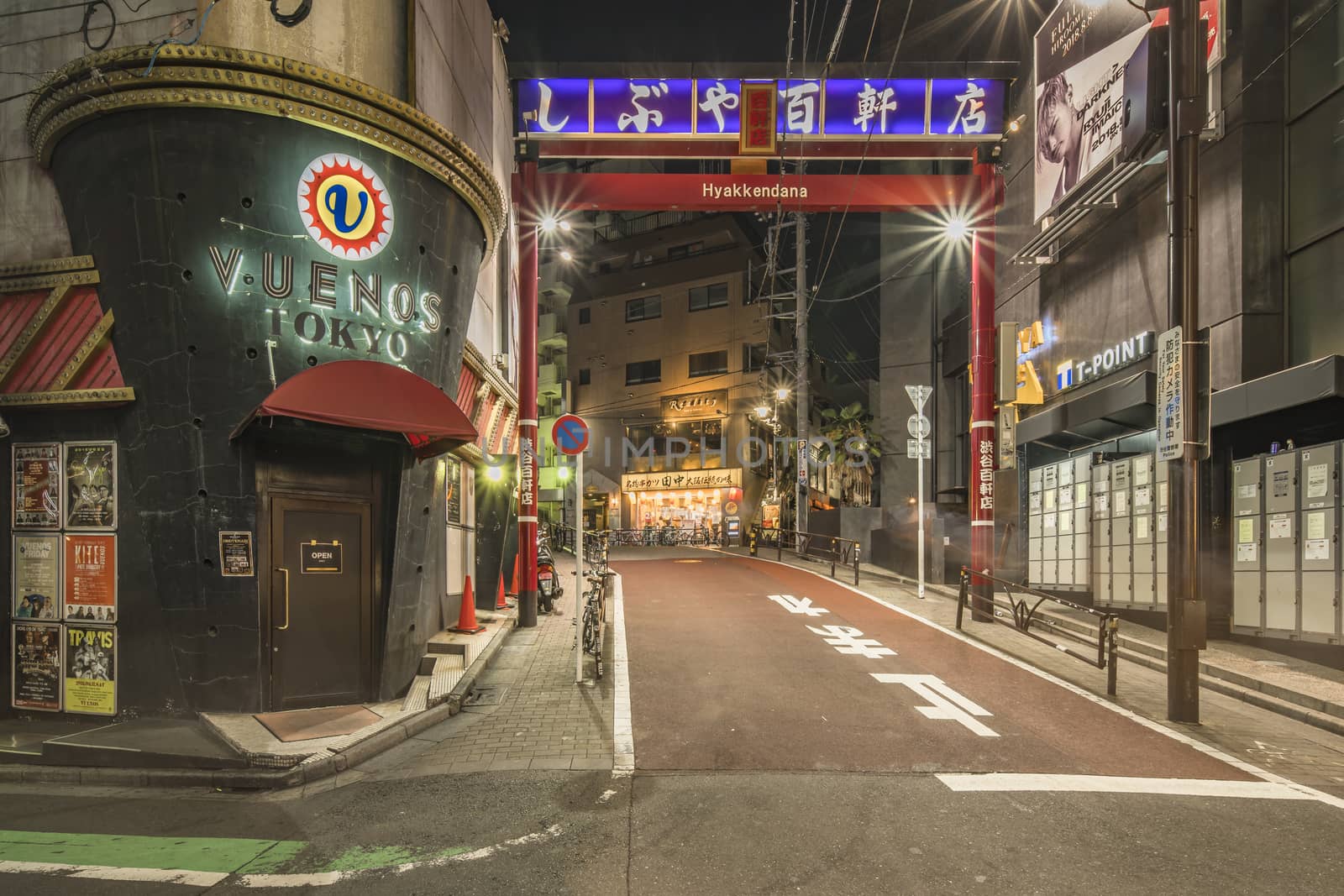 Red portal of the shopping street Hyakkendana located in a street adjacent to the Dogenzaka avenue which leads to the Shibuya Crossing Intersection in front of Shibuya Station on night. This street which was born in the 20's will become until the 70's the central district of Shibuya with no less than 120 stores including many cafes theaters and cinemas and now dance clubs and love hotels.