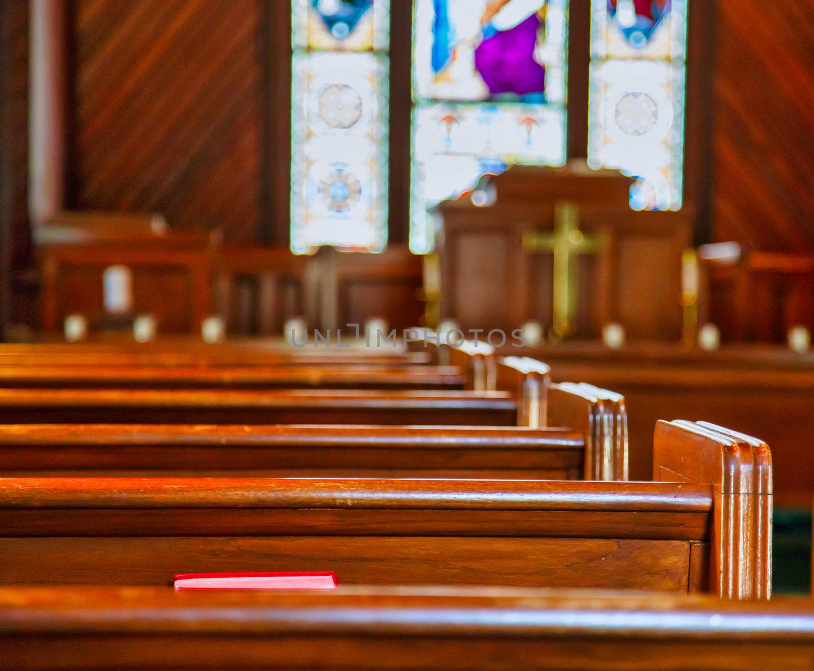 Stained glass windows in small church with wood pews