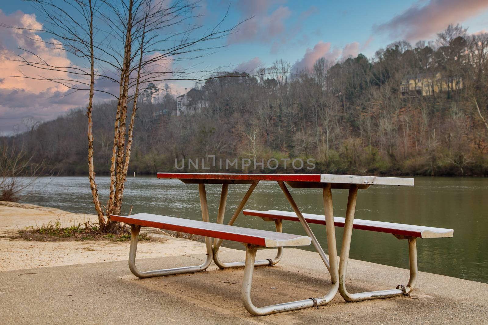 Empty metal on concrete pad in park by a river